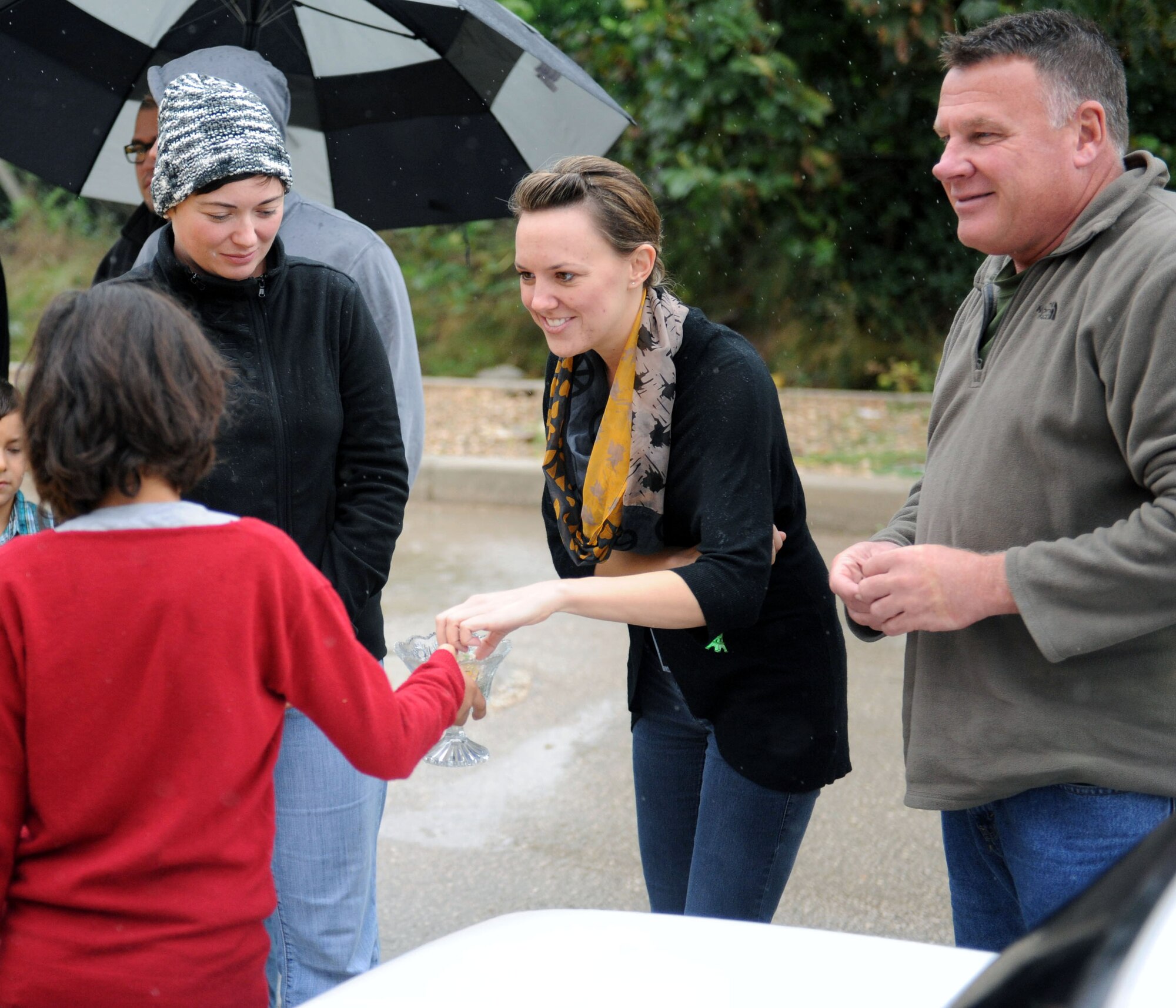 Staff Sgt. Anne Phillips, Senior Airman Michelle Horter, and Senior Master Sgt. Richard Tigges, all members of the 90th Expeditionary Air Refueling Squadron, visit with a young member of the local community outside the gates of Incirlik Air Base, Turkey.  All three deployed Airmen are Air Force Reservists assigned to the 931st Air Refueling Group, McConnell Air Force Base, Kan.  (U.S. Air Force photo by Senior Airman Clayton Lenhardt)