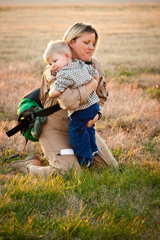 Maj. Jennifer Helton, a navigator for the 165th Airlift Squadron, fights back tears Nov. 10, 2012, as she hugs her son next to the flight line of the Kentucky Air National Guard Base in Louisville, Ky. Helton was one of 58 Kentucky Air Guardsmen returning from a four-month deployment to the Persian Gulf region. (U.S. Air Force photo by Maj. Dale Greer)