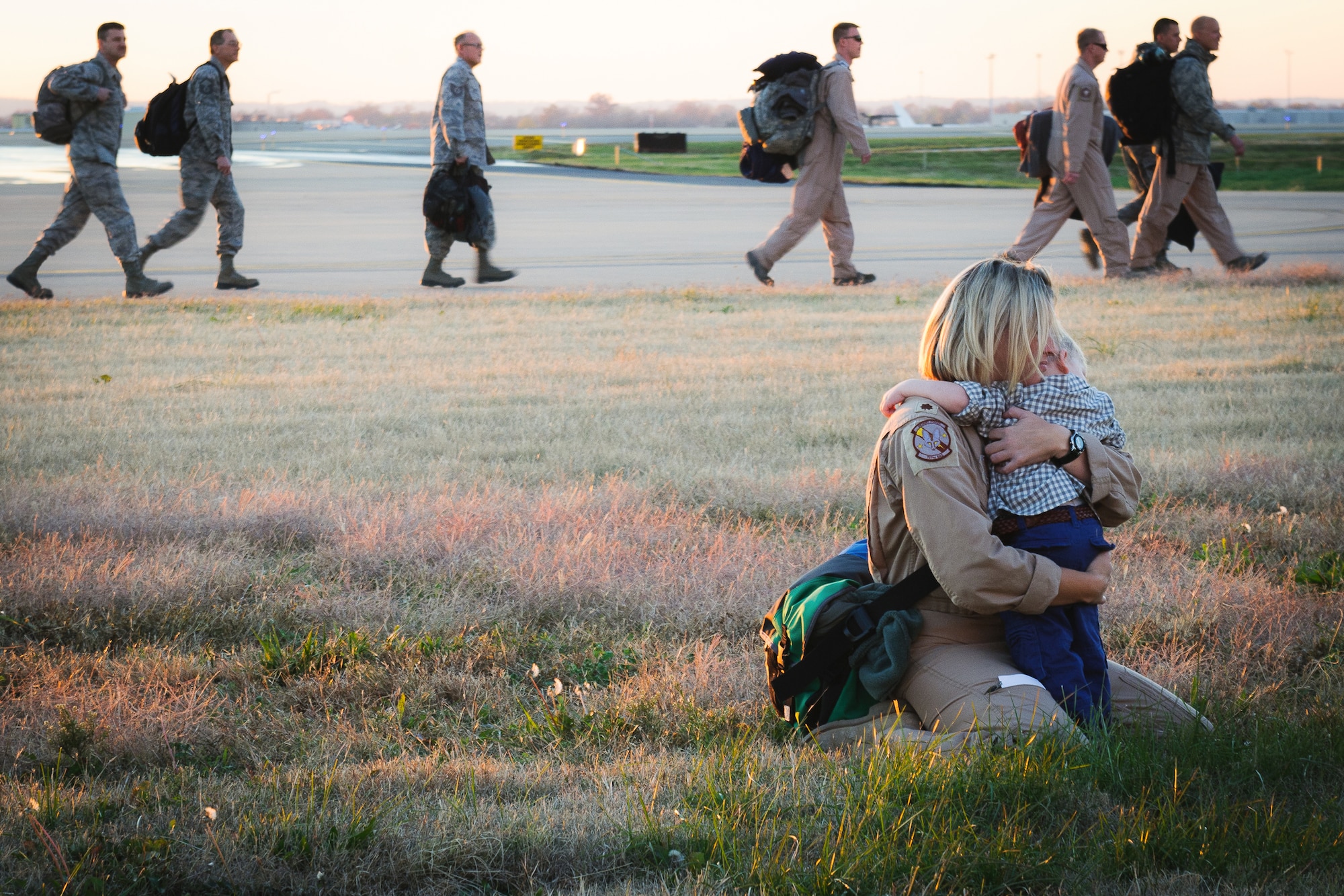 Maj. Jennifer Helton, a navigator for the 165th Airlift Squadron, hugs her son next to the flight line of the Kentucky Air National Guard Base in Louisville, Ky., Nov. 12, 2012. Helton was one of 58 Kentucky Air Guardsmen returning from a four-month deployment to the Persian Gulf region. (U.S. Air Force photo by Airman Basic Joshua L. Horton)