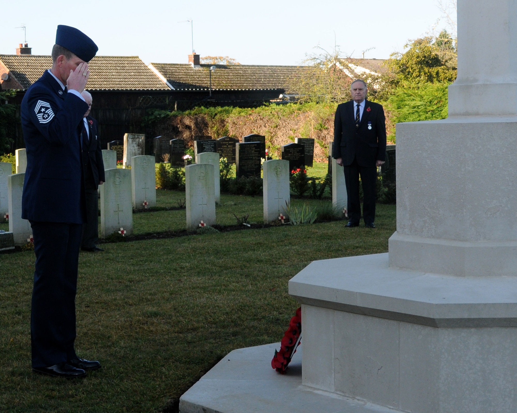 Chief Master Sgt. Christopher Powell, 100th Air Refueling Wing command chief, salutes the World War I and World War II memorial, during a Remembrance Day wreath-laying ceremony Nov. 11, 2012, in Beck Row, England. Remembrance Day is held on Nov. 11 every year as a way to pay respect to military members who lost their lives. (U.S. Air Force Photo by Airman 1st Class Kelsey Waters/Released)