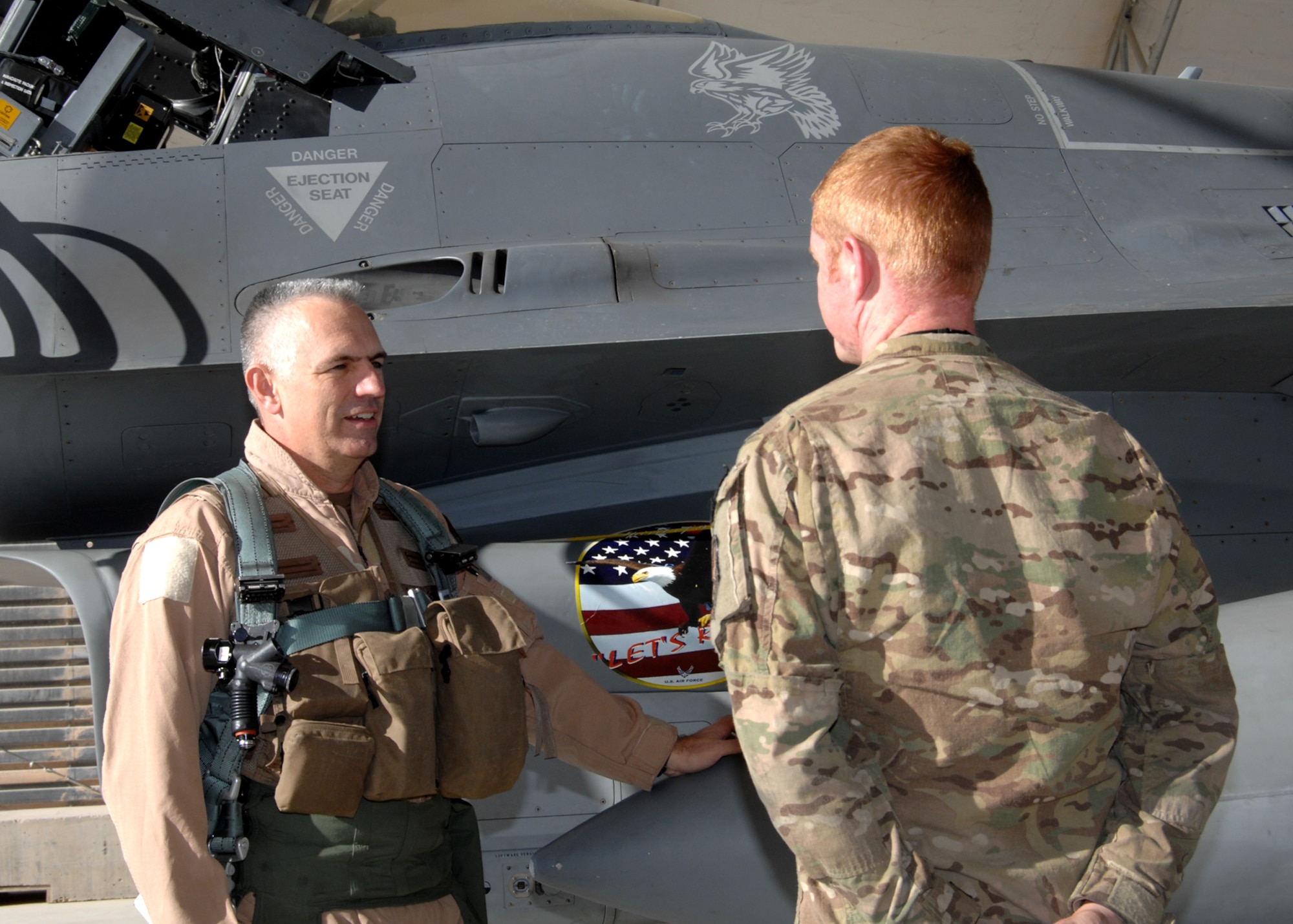 U.S. Air Force Brig. Gen. Scott Dennis, 451st Air Expeditionary Wing and Kandahar Airfield Commander, talks to Airman 1st Class Jack Boswell, 451st Expeditionary Aircraft Maintenance Squadron F-16 crew chief, as the general prepares to fly a combat sortie on Nov. 8. (U.S. Air Force photo/Master Sgt. Russell Martin) 