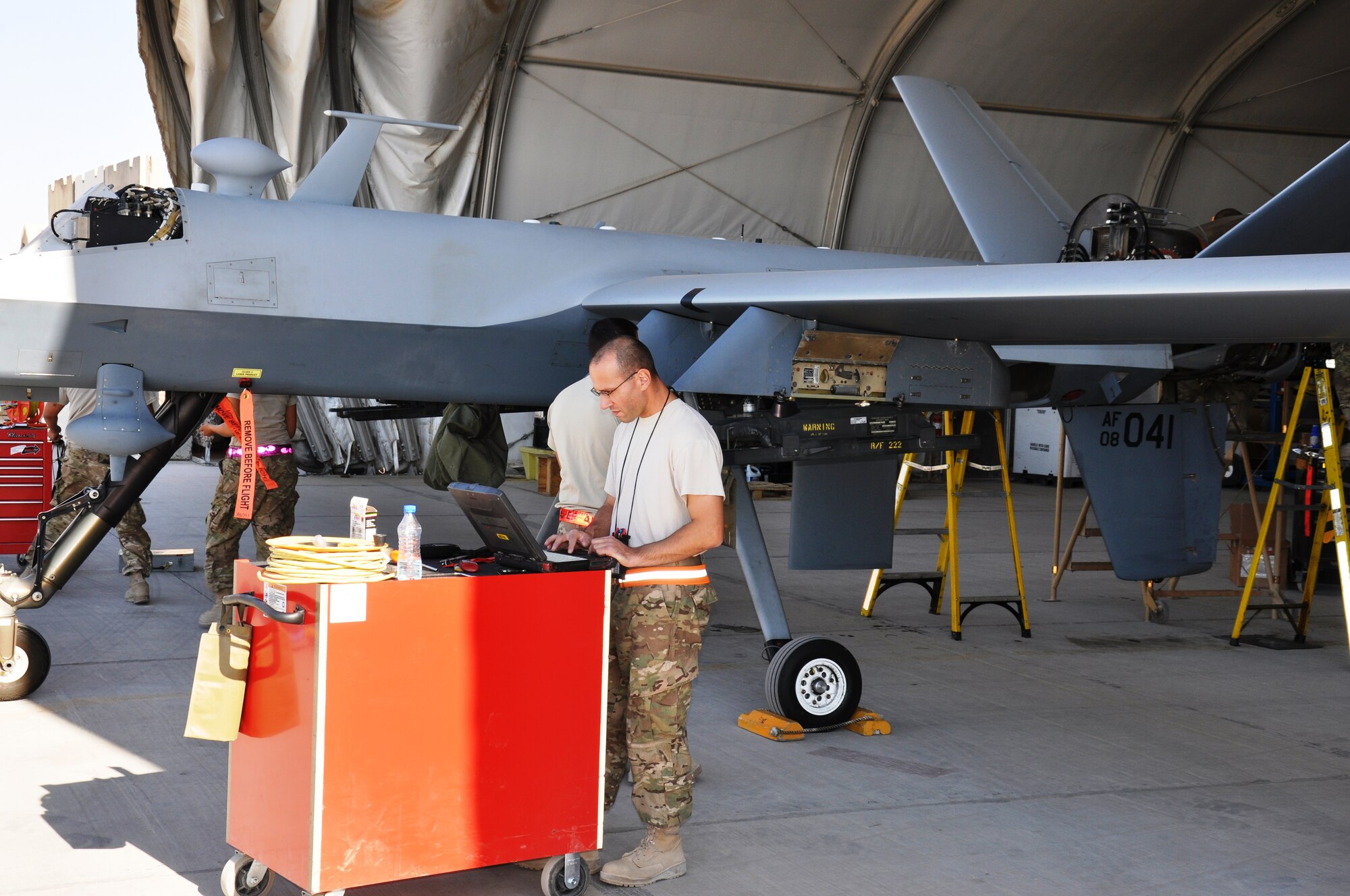 Tech. Sgt. Joseph Sullivan, an MQ-9 Reaper specialist, performs scheduled maintenance on avionics equipment on Nov. 3, 2012. Sullivan is part of the MQ-9 Aircraft Maintenance Unit, 451st Expeditionary Aircraft Maintenance Squadron at Kandahar Airfield. (U.S. Air Force photo/Capt. Tristan Hinderliter) 