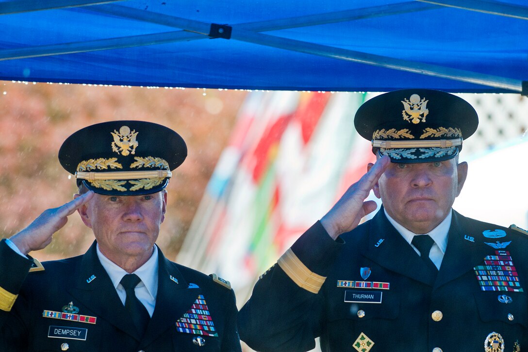 U.S. Army Gen Martin E. Dempsey, chairman of the Joint Chiefs of Staff, and U.S. Army Gen. James D. Thurman, commander of Combined Forces Command Korea and U.S. Forces Korea, participate in a Veterans Day ceremony at the 8th Army Memorial in Yongsan, South Korea, Nov. 11, 2012.