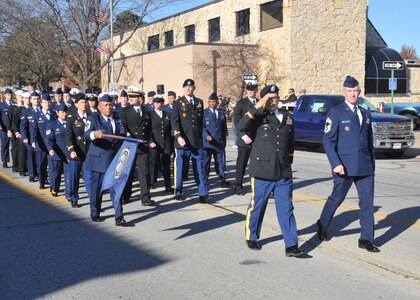 Omaha, Neb. - Servicemembers assigned to U.S. Strategic Command, Offutt Air Force Base, Neb., render honors during a Veteran&#039;s Day parade Nov. 11, 2012 in Bellevue, Neb. Veterans Day is an official federal holiday which honors people who have served in armed forces. It coincides with other holidays observed around the world, such as Armistice Day and Remembrance Day, and also marks the anniversary of the end of World War I.
