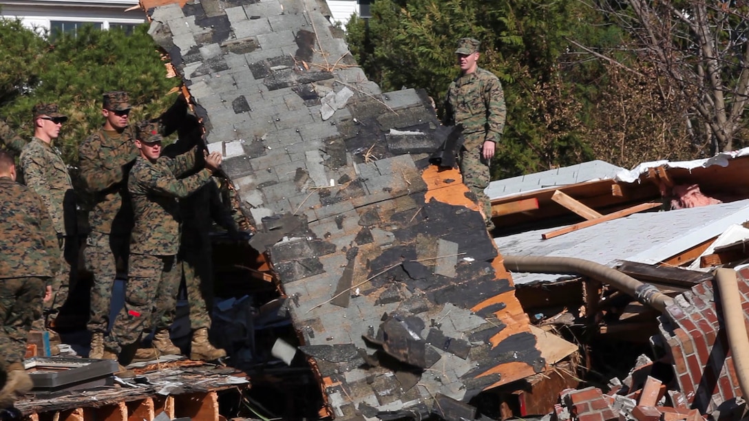 Marines and sailors of the 26th Marine Expeditionary Unit (MEU), and sailors assigned to the USS Wasp (LHD 1), cleared debris and helped locals in moving damaged property from roadways at Rockaway Beach, N.Y., Nov. 09, 2012. The Marines and sailors worked in a collabrative effort to help after the area was damaged by Hurricane Sandy, which destroyed many peoples homes. The 26th MEU operates continuously across the globe, providing the president and unified combatant commanders with a forward-deployed, sea-based quick reaction force. The MEU is a Marine Air-Ground Task Force capable of conducting amphibious operations, crisis response, and limited contingency operations. They are slated to deploy in 2013.(U.S. Marine Corps photograph by Cpl. Kyle N. Runnels)