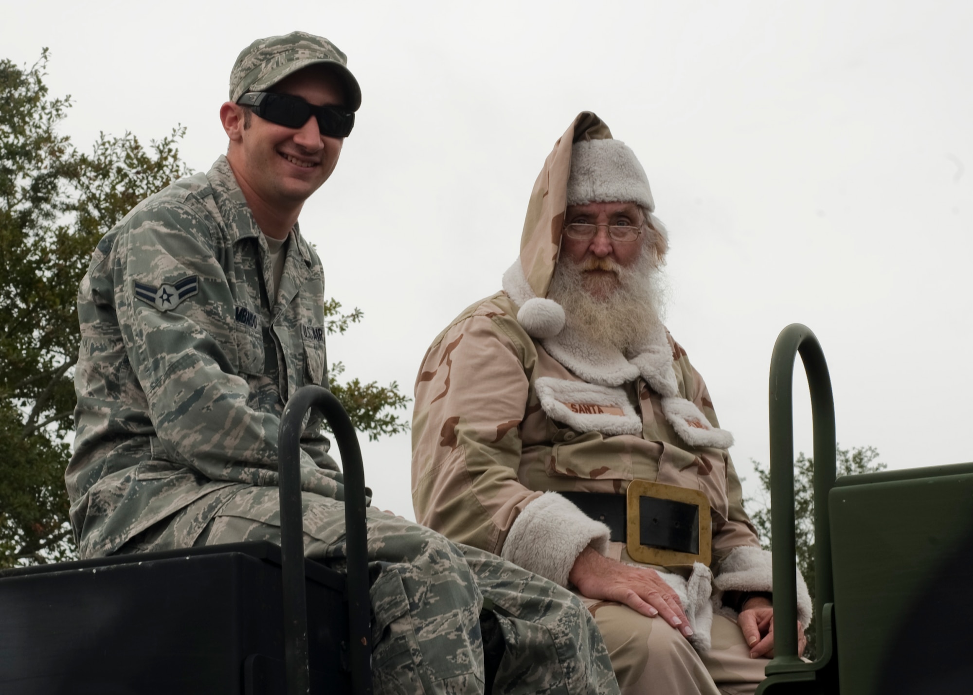 United States Air Force Airman 1st Class Zachary Lombardo, vehicle operations apprentice of 1st Special Operations Logistics Readiness Squadron sits with Santa Claus at the Veteran's Day Parade in Santa Rosa, Fla., Nov. 12, 2012. Military members participated in the Veteran's Day Parade to honor veterans of the present and past. (U.S. Air Force photo / Airman 1st Class Nigel Sandridge)