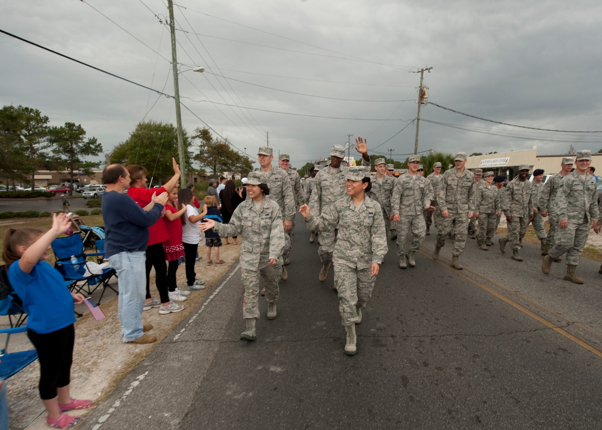 United States Air Force Airmen wave to the crowd at the Veteran's Day Parade at the Santa Rosa mall in Mary Esther, Fla., Nov. 12, 2012. Military members participated in the Veteran's Day Parade to honor veterans of the present and past. (U.S. Air Force photo / Airman 1st Class Nigel Sandridge)