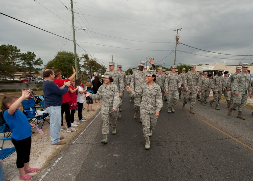 United States Air Force Airmen wave to the crowd at the Veteran's Day Parade at the Santa Rosa mall in Mary Esther, Fla., Nov. 12, 2012. Military members participated in the Veteran's Day Parade to honor veterans of the present and past. (U.S. Air Force photo / Airman 1st Class Nigel Sandridge)