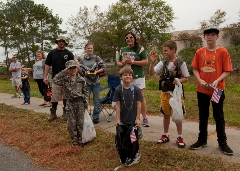 Children and parents cheer on Hurlburt Field Airmen during the Veteran's Day Parade at the Santa Rosa in Mary Esther, Fla., Nov. 12, 2012. Military members participated in the Veteran's Day Parade to honor veterans of the present and past. (U.S. Air Force photo / Airman 1st Class Nigel Sandridge)