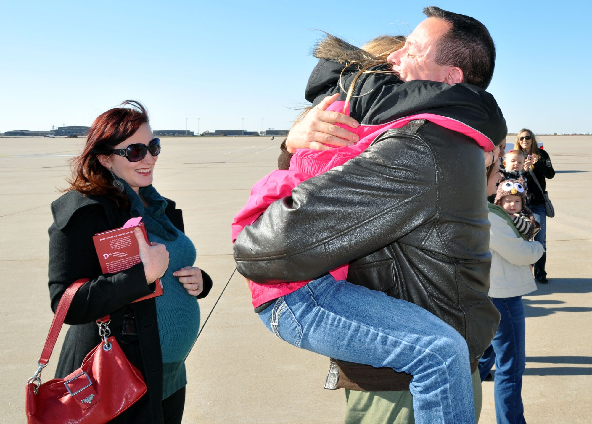 Lt. Col. Travis Clark, a pilot assigned to the 18th Air Refueling Squadron, 931st Air Refueling Group, embraces his daughter, Gabby, as his wife, Angie, looks on at McConnell Air Force Base, Kan, Nov. 12, 2012.  Clark had just returned from serving for more than two months deployed as a member of the 90th Expeditionary Air Refueling Squadron at Incirlik Air Base, Turkey.  (U.S. Air Force photo by 1st Lt. Zach Anderson)