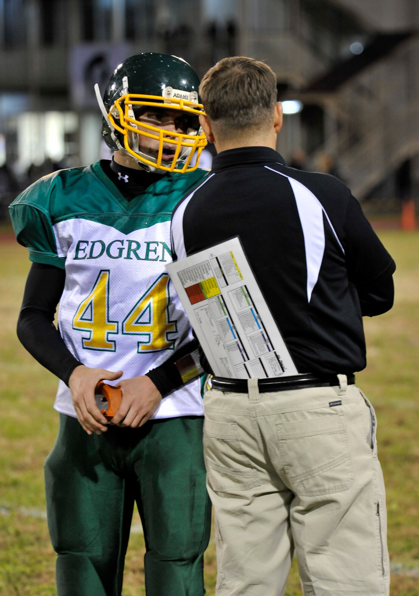 Edgren Eagles head coach Blaine Miller talks to kicker Chris Finco before the Eagles kickoff during the Division II championship game at Camp Zama, Japan, Nov. 10, 2012. Although only being down 14-12 at halftime, Edgren failed to make much noise in the second half, falling to the Zama Trojans 35-20. (U.S. Air Force photo by Airman 1st Class Zachary Kee)