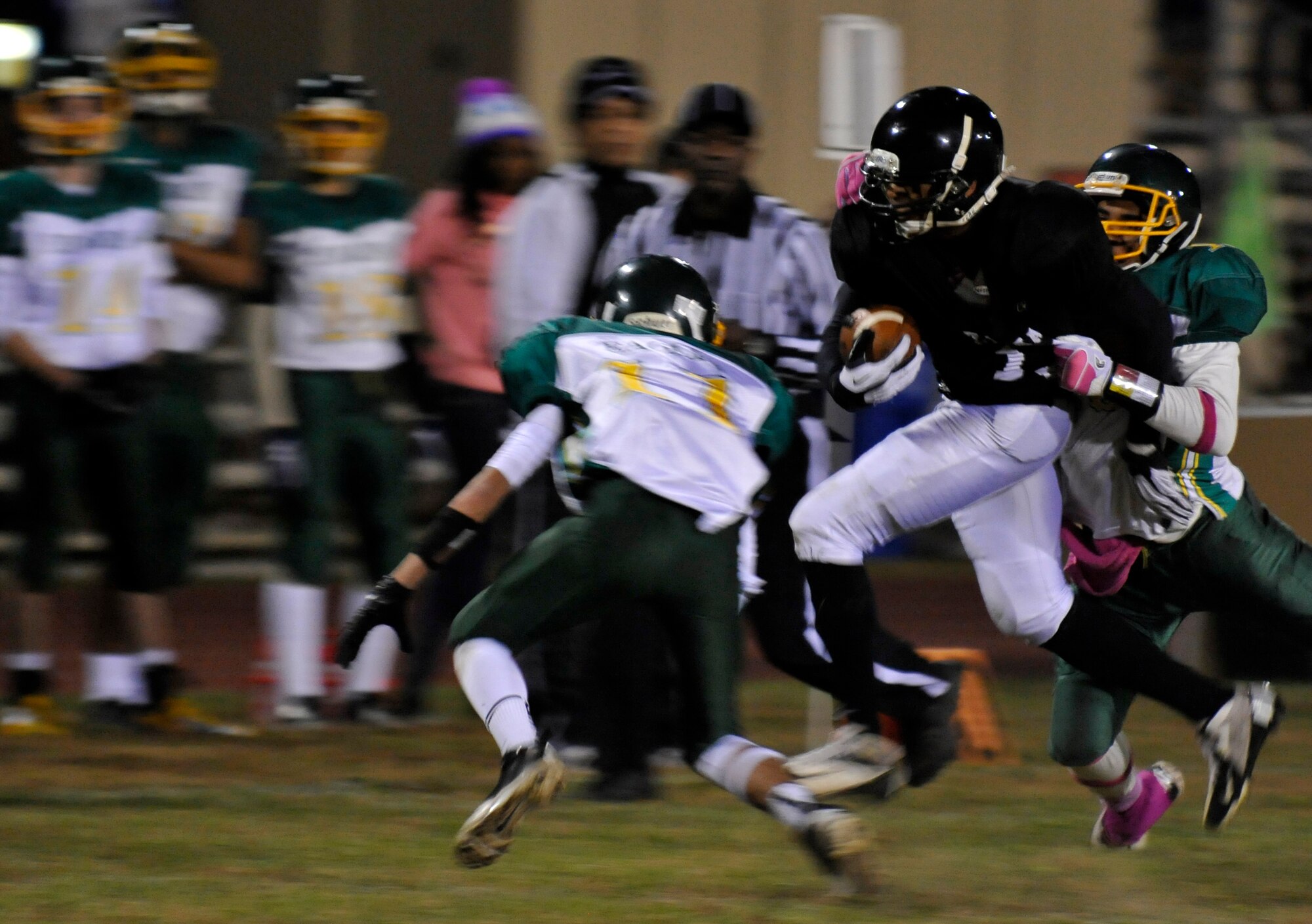 Zama Trojans running back Mitchell Harrison fights for extra yards as Edgren Eagles tackler Khalil Williams brings him down during the Division II championship game at Camp Zama, Japan, Nov. 10, 2012. Edgren was defeated by Zama 35-20, as Zama won their third title in five years. (U.S. Air Force photo by Airman 1st Class Zachary Kee)