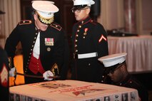 Marine Corps Forces Central Command Deputy Commanding General, BGen. Gregg P. Olson, cuts into the traditional birthday cake during the 237th Marine Corps Birthday Ball Celebration. The birthday cake is traditionally cut with the Mameluke sword, as a reminder that we are a band of warriors, committed to carrying the sword, so that our nation may live in peace.