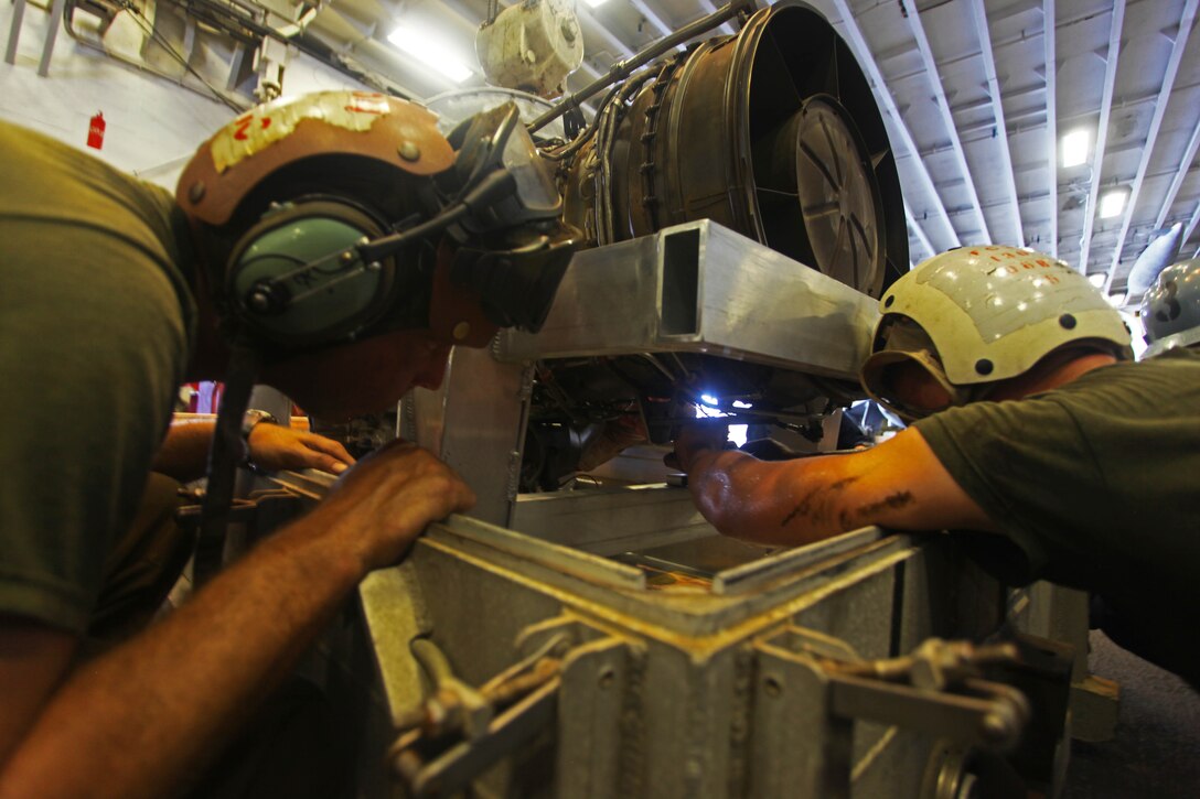 USS IWO JIMA, U.S. 5th Fleet Area of Responsibility (Sept 22, 2012) -Marines from the airframes section with Marine Medium Tiltrotor Squadron 261 (Reinforced), 24th Marine Expeditionary Unit, conduct engine maintenance on an MV-22B Osprey engine in the hangar of USS Iwo Jima (LHD 7), Sept 22, 2012. The aviation maintenance crews work around the clock to ensure the 24th MEU's aircraft are always ready to fly in support of the various missions they could be called for. The 24th MEU is deployed with the Iwo Jima Amphibious Ready Group as a theater reserve and crisis response force for U.S. Central Command in the U.S. Navy's 5th Fleet area of responsibility. (U.S. Marine Corps photo by Lance Cpl. Tucker S. Wolf) 