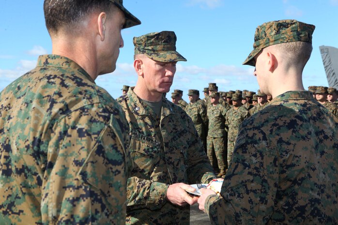 USS IWO JIMA,NAVAL STATION ROTA (Nov. 11, 2012) - Lt. Col. Ronald Perry, the oldest Marine present during the 24th Marine Expeditionary Unit's birthday ceremony celebrating the Marine Corps' 237th birthday, passes the traditional birthday cake to the youngest Marine present, Lance Cpl. Jeffrey Tobash, aboard USS Iwo Jima Nov. 11, 2012.  The 24th MEU is deployed with the Iwo Jima Amphibious Ready Group and is currently in the 6th Fleet Area of Responsibility as a disaster relief and crisis response force. Since deploying in March, they have supported a variety of missions in the U.S. Central and European Commands, assisted the Navy in safeguarding sea lanes, and conducted various bilateral and unilateral training events in several countries in the Middle East and Africa. The 24th MEU is scheduled to return to their home bases in North Carolina later this year. (U.S. Marine Corps photo by Gunnery Sgt. Chad R. Kiehl/Released)