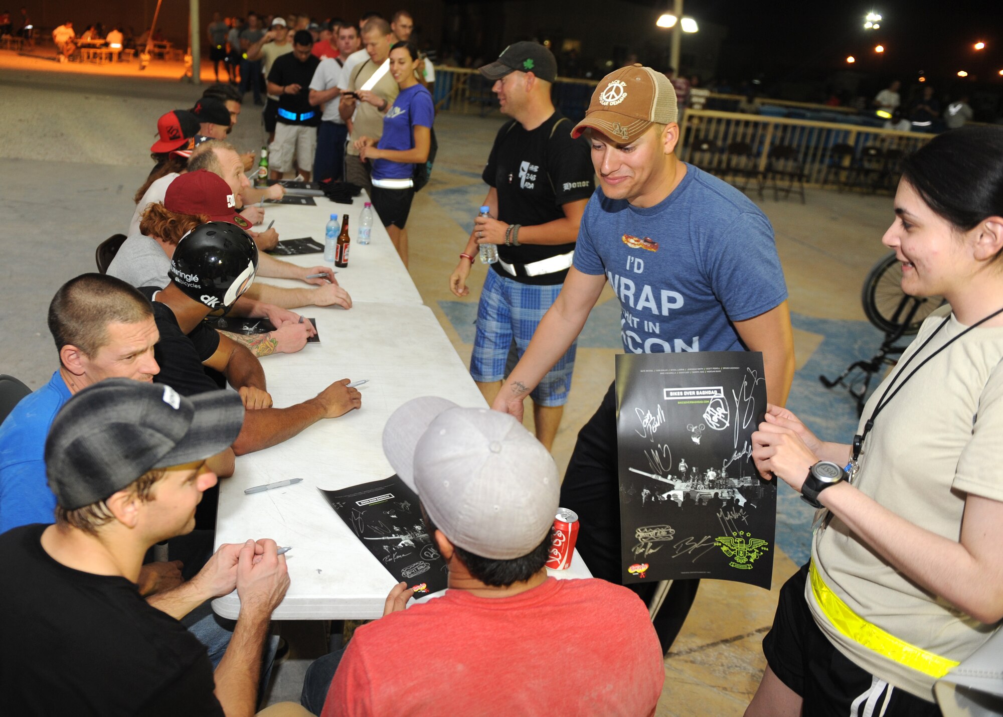 SOUTHWEST ASIA – Team members from Bikes over Baghdad sign autographs for U.S. Armed Forces and Coalition members Nov. 11, 2012, following a successful performance recognizing service members for their service. Bikes over Baghdad started in 2009, when a group of BMX professionals wanted to show their appreciation for U.S. service members by providing demonstrations across the area of responsibility. Today their show is one of the most requested by fans across the AOR.   (U.S. Air Force/Senior Airman Joel Mease)