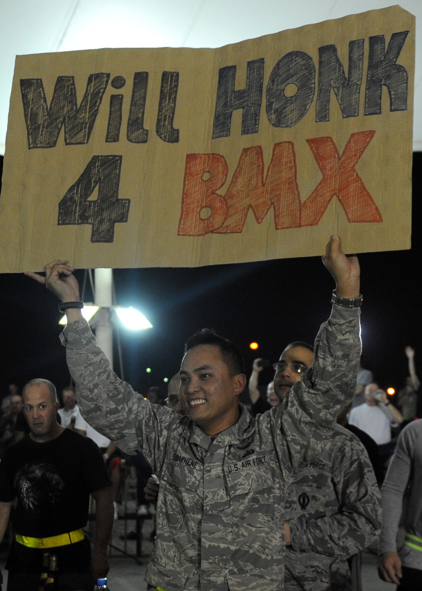 SOUTHWEST ASIA - Master Sgt. Sack Sounakhene, 379th Expeditionary Operations Support Squadron, shows his enthusiasm for the Bikes over Baghdad BMX team during their performance Nov. 11, 2012. This was the first stop of their tour across the area of responsibility. Riders on the tour include Brian Kachinsky, Chad Kagy, Mykel Larrin, Morgan Wade, Jeremiah Smith and Scott Powell; ramp builders Nate Wessel and Ron Kimler and announcer Darryl Nau. (U.S. Air Force/Senior Airman Joel Mease)