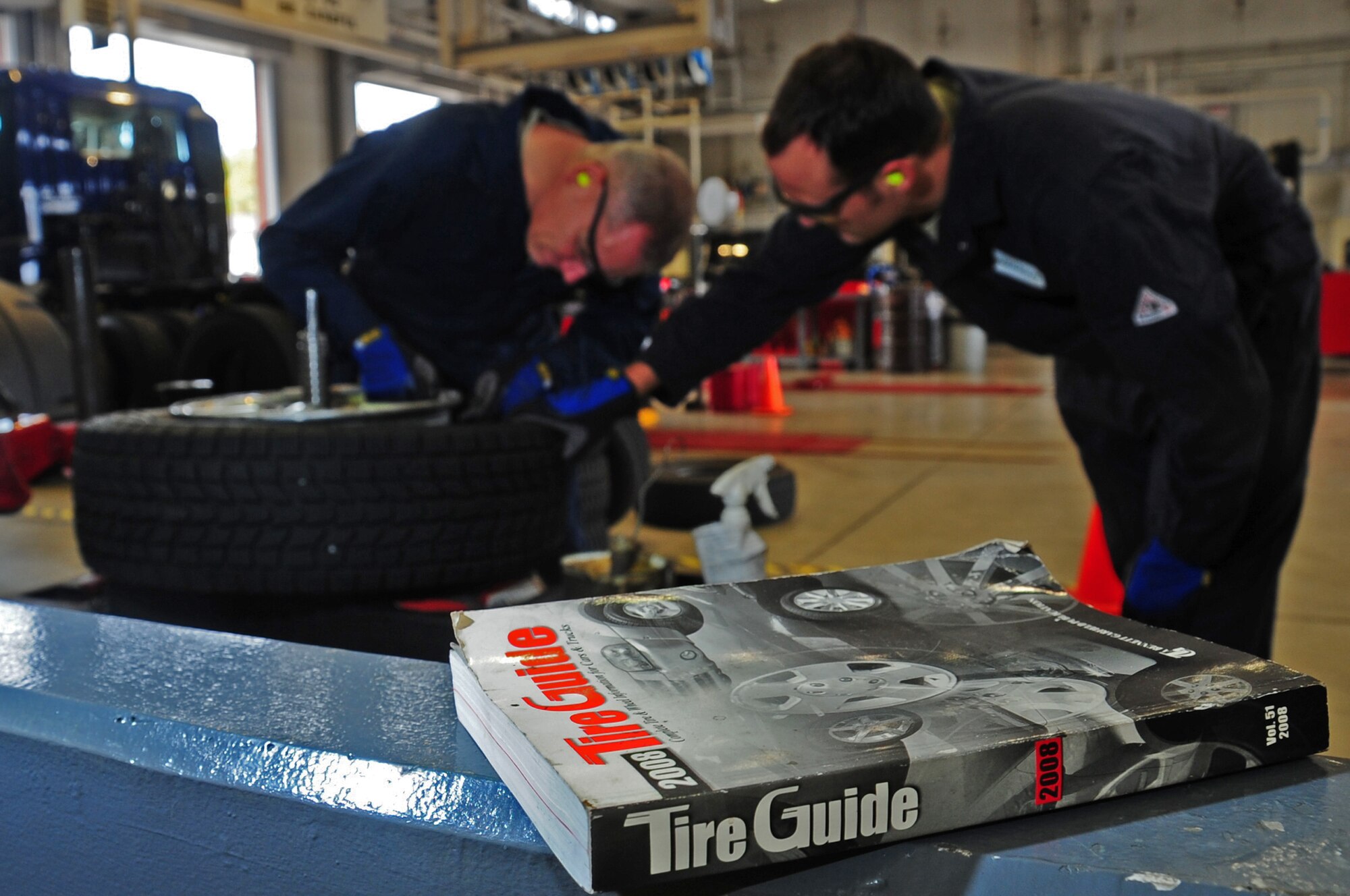 U.S. Air Force Senior Airman Sean Anderson, 35th Logistics Readiness Squadron vehicle management journeymen, guides Chief Master Sgt. James Laurent, 35th Fighter Wing command chief, through changing tires to get the base government vehicles ready for the winter season at Misawa Air Base, Japan, Nov. 13, 2012.  Chief Laurent initiated the Dirty Job program to give the Airmen of Misawa AB a chance to share their knowledge and skills with their leadership.