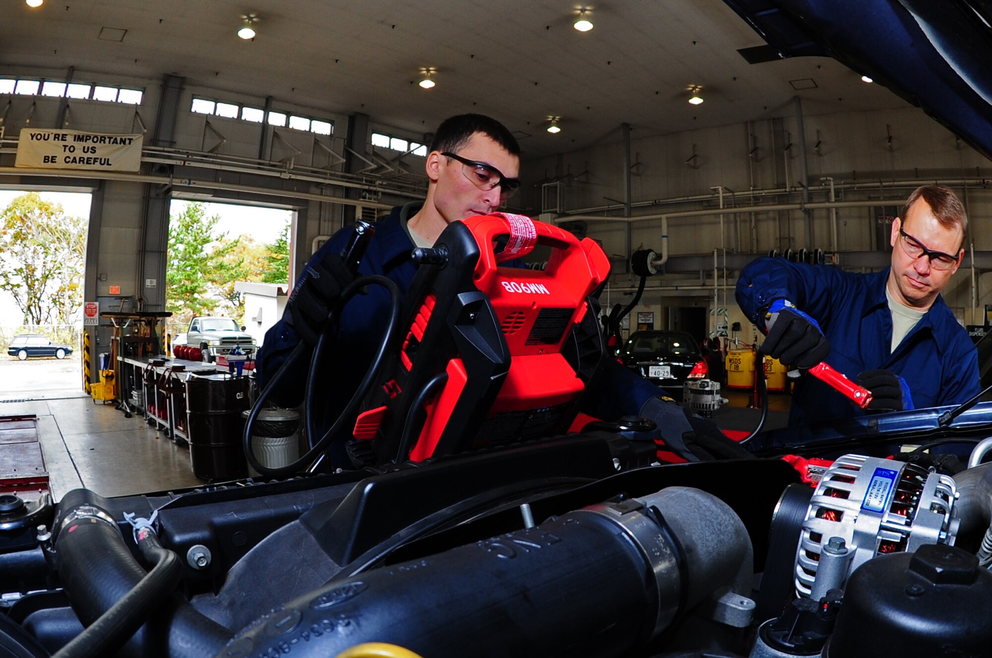 U.S. Air Force Airman 1st Class Alan Wilkins, 35th Logistics Readiness Squadron vehicle management journeymen, tests the battery in a vehicle after changing the alternator with assistance from Col. Stephen Williams, 35th Fighter Wing commander, during the Command Chief’s dirty job program at Misawa Air Base, Japan, Nov. 13, 2012.  The Dirty Job program allows Airmen from the many different career fields of the Air Force to showcase their hard work and dedication to their jobs to base leadership. 
