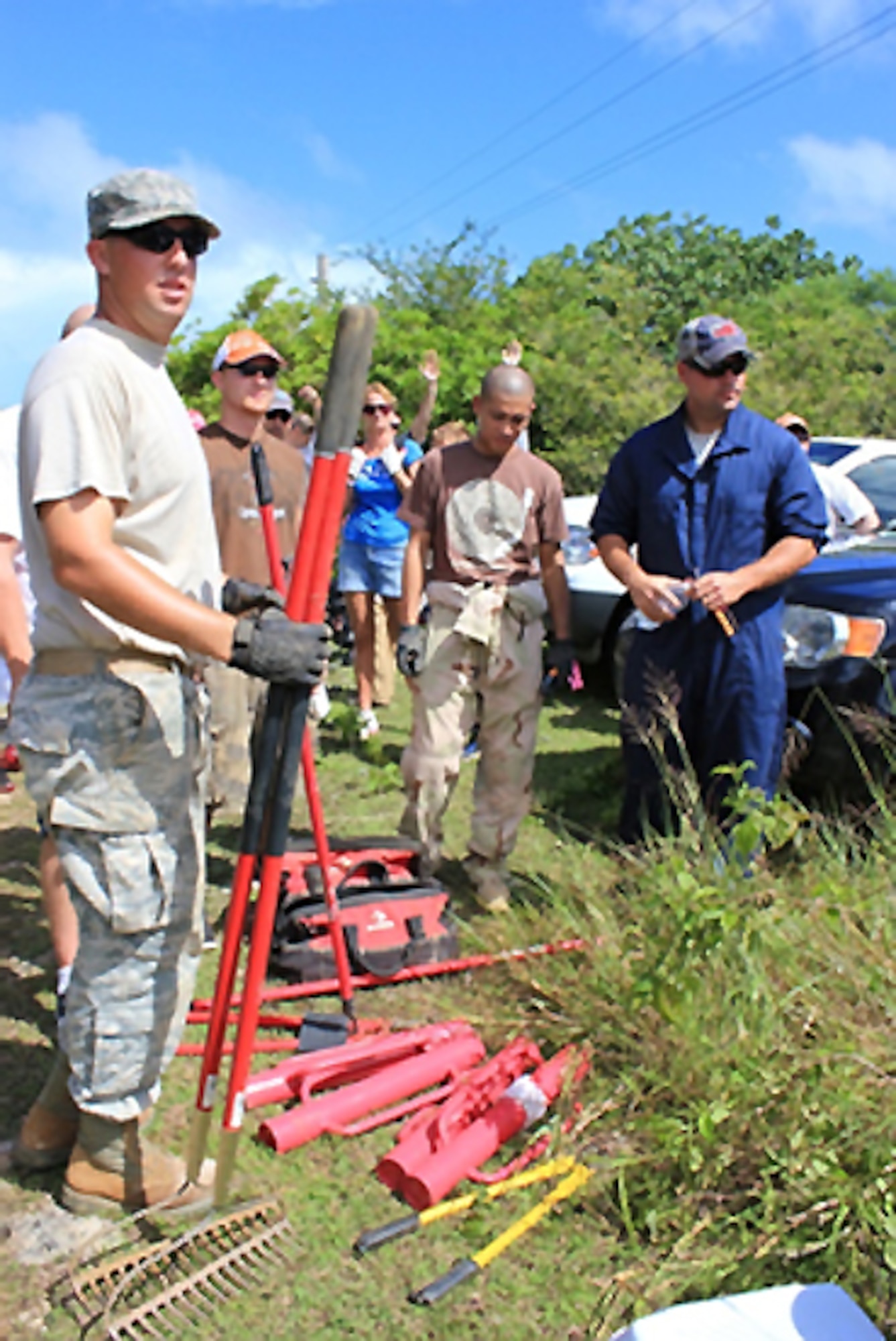 NORTHWEST FIELD, Guam – Volunteers repair the seven-foot high ungulate-proof fence here, Oct. 29. The 36th Civil Engineer Squadron Environmental Flight hosted a volunteer work day for military personnel and their families by assisting in the replacement and repair of an ungulate, deer and pig proof, fence around the federally endangered Fire Tree. (U.S. Air Force courtesy photo/Released)