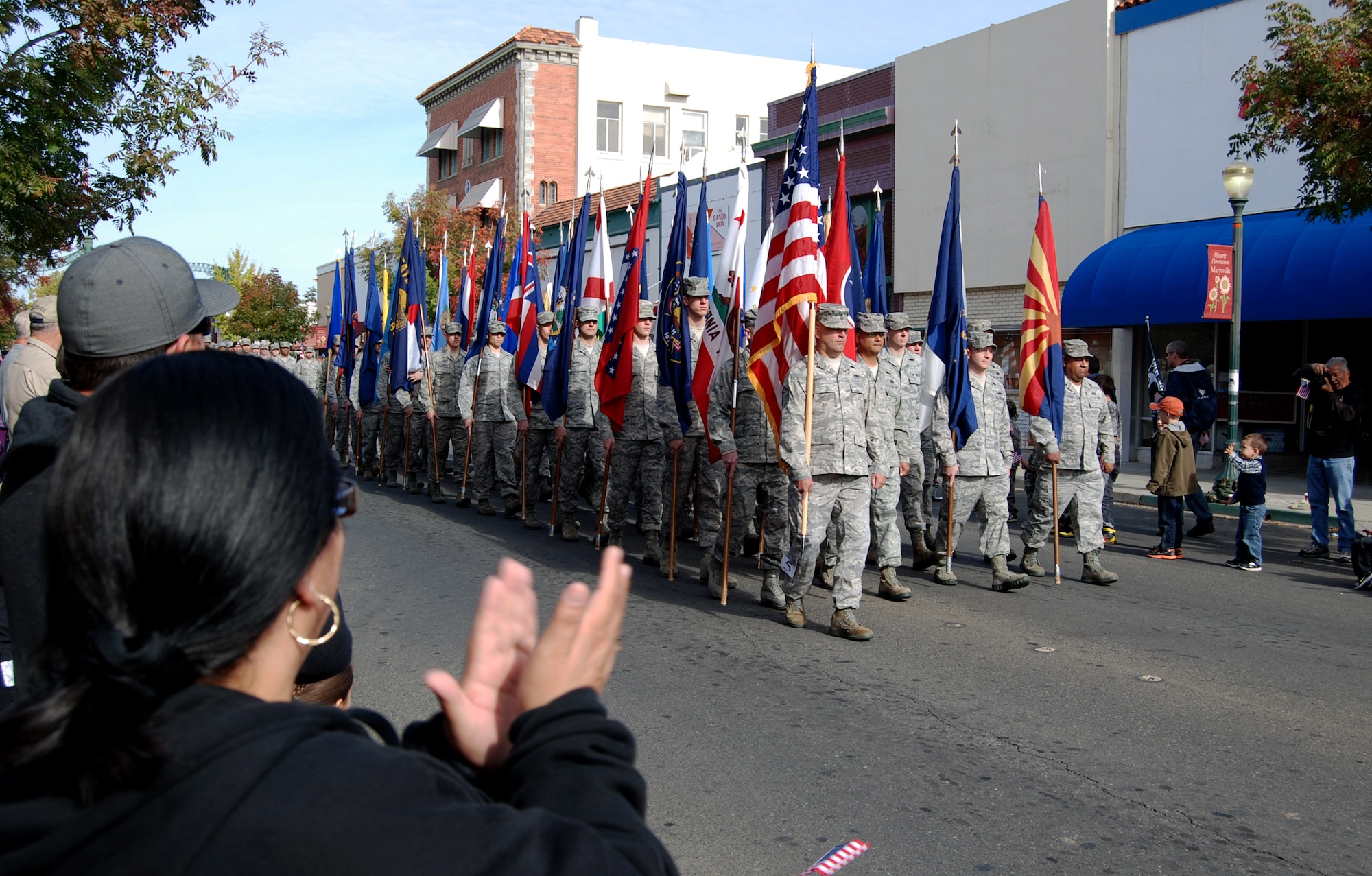 The 9th Communications Squadron marches with the state flags during the Yuba-Sutter Veterans Day Parade in Marysville, Calif., Nov. 11, 2012. More than 400 Team Beale Airmen participated in the parade. (U.S. Air Force photo by Capt. Brian Wagner/Released)