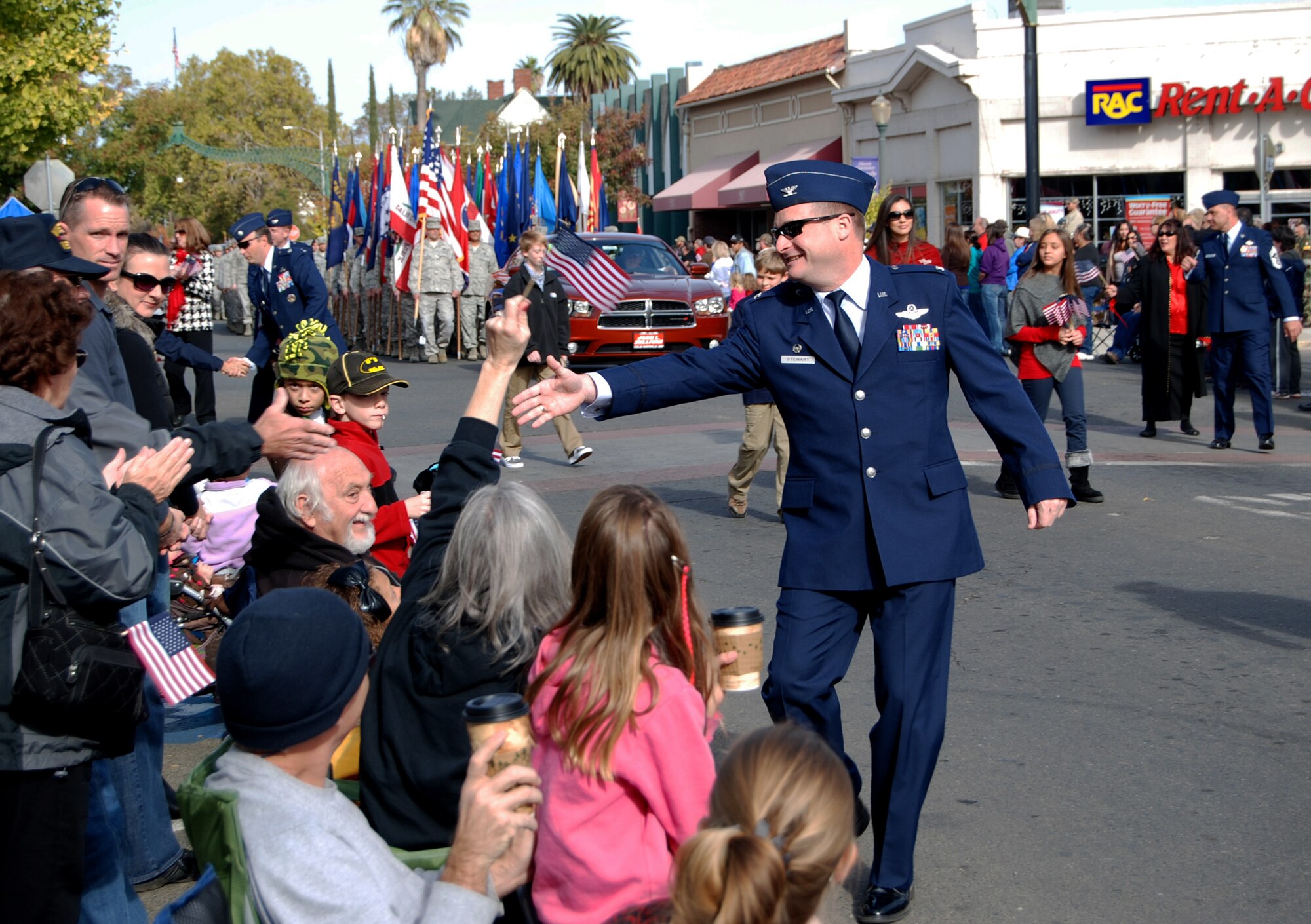 Col. Phil Stewart, 9th Reconnaissance Wing commander, shakes hands along the parade route during the Yuba Sutter Veterans Day Parade in Marysville, Calif., Nov. 11, 2012. More than 400 Team Beale Airmen participated in the parade. (U.S. Air Force photo by Capt. Brian Wagner/Released)