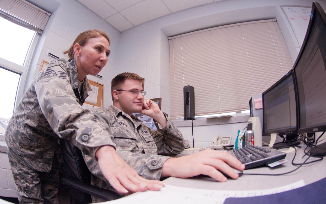 Master Sgt. Susan Grinde, 34th Aircraft Maintenance Unit specialist section chief, advises Staff Sgt. Samuel Coffin, 34th AMU offensive avionics system specialist, on opportunities for mentoring the shop’s Airmen, Nov. 13, 2012 at Ellsworth Air Force Base, S.D. Aside from her primary duties, Grinde dedicates time to those in need as an Ellsworth victim advocate. (U.S. Air Force Photo by Airman 1st Class Audra M. Hornbacher/Released)