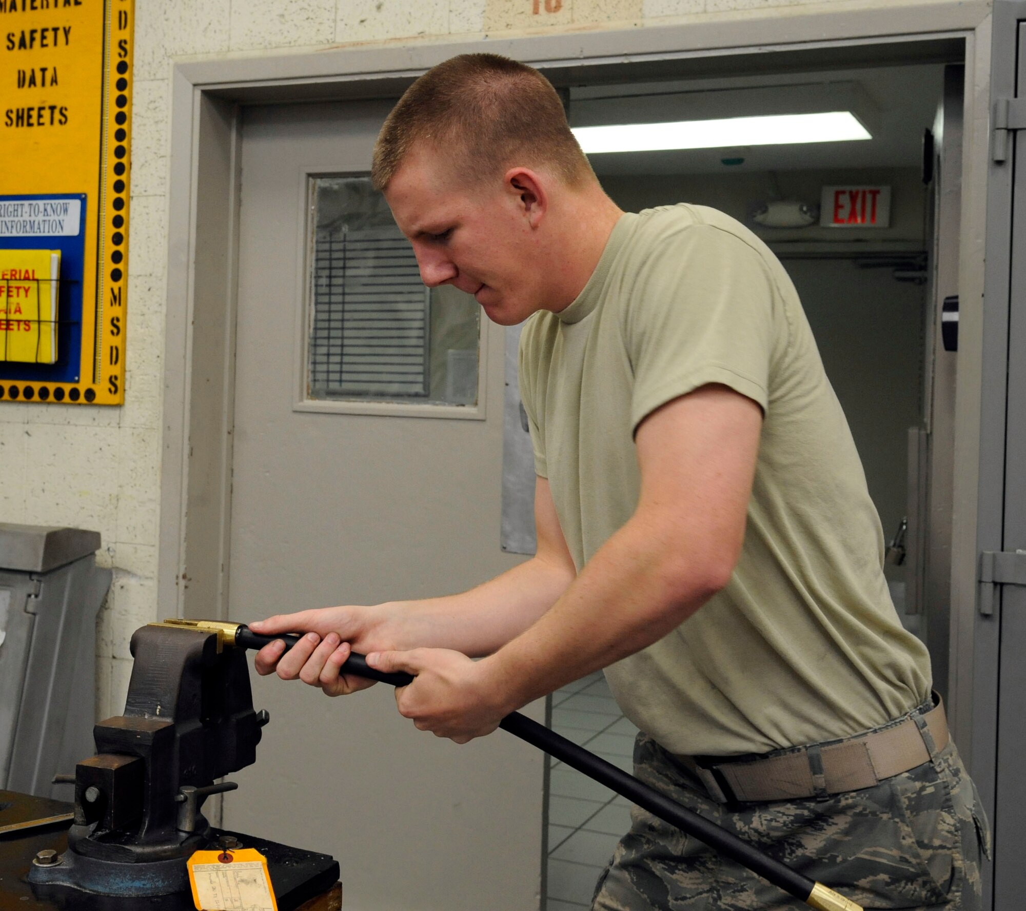Airman 1st Class Taylor Davis, 2nd Maintenance Squadron Hydraulics section, attaches fittings to a high pressure hydraulic hose on Barksdale Air Force Base, La., Nov. 13. The Airmen assigned to the hydraulics section are responsible for the hydraulics systems of Barksdale's B-52H Stratofortress bombers, which assist the aircraft in steering, landing and opening of the bomb-bay doors. (U.S. Air Force photo/Airman 1st Class Andrew Moua)(RELEASED)