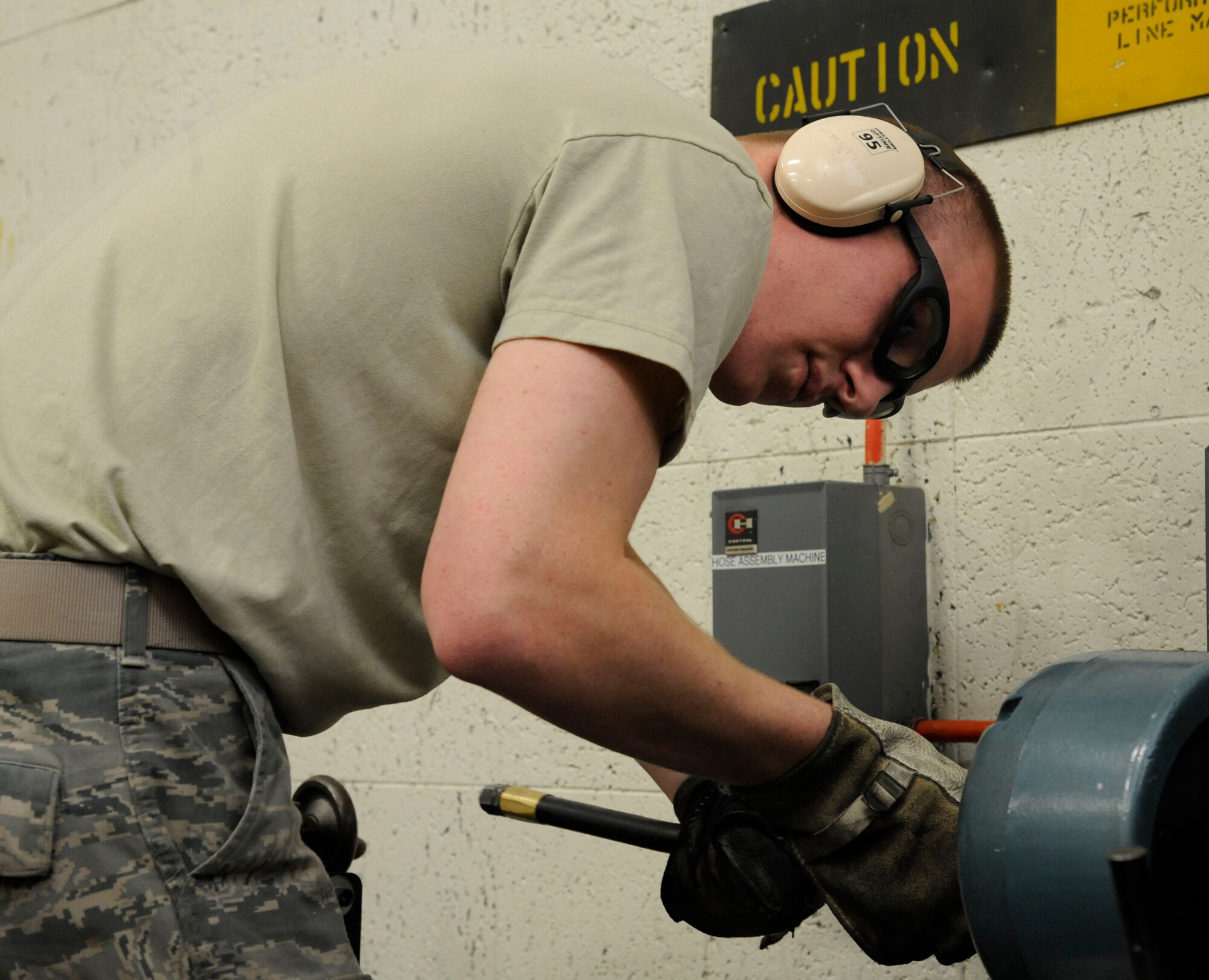 Airman 1st Class Taylor Davis, 2nd Maintenance Squadron Hydraulics section, uses a skiving machine to cut a high pressure hydraulic hose on Barksdale Air Force Base, La., Nov. 13. Airmen new to the squadron practice with every piece of equipment they will be expected to repair once fully trained. (U.S. Air Force photo/Airman 1st Class Andrew Moua)(RELEASED)