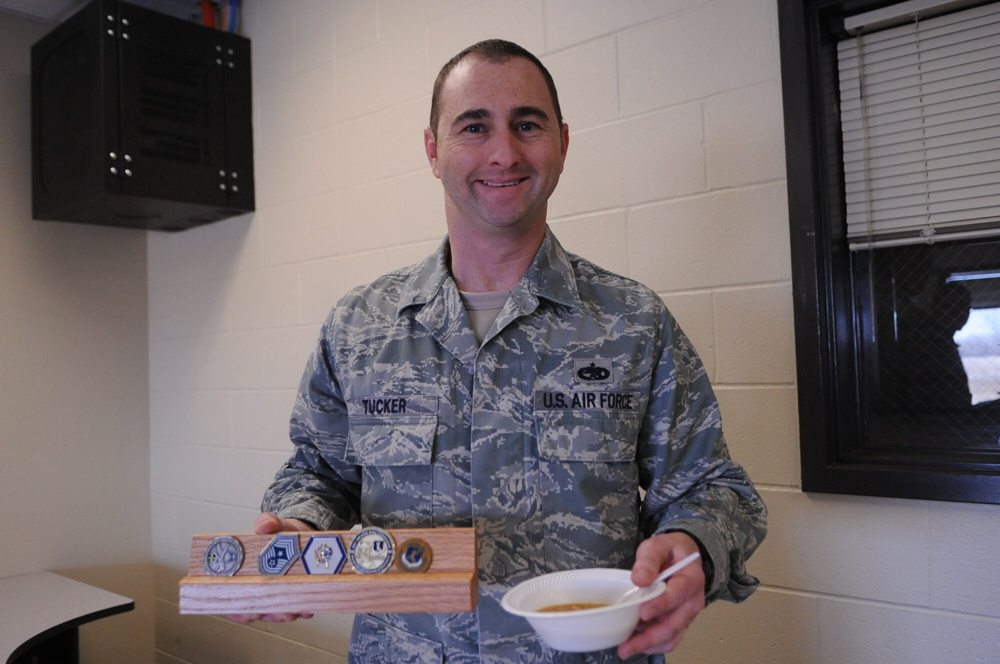 Tech. Sgt. Jeremy Tucker, 69th Maintenance Squadron, walked away with the top five challenge coins on Grand Forks Air Force Base after being named the winner of the Wing Safety Day Chili Cook-off here Nov. 5, 2012. Wing Safety Day featured speakers from the base and local community to promote safe practices for the coming winter. (U.S. Air Force photo/Staff Sgt. Amanda N. Grabiec)