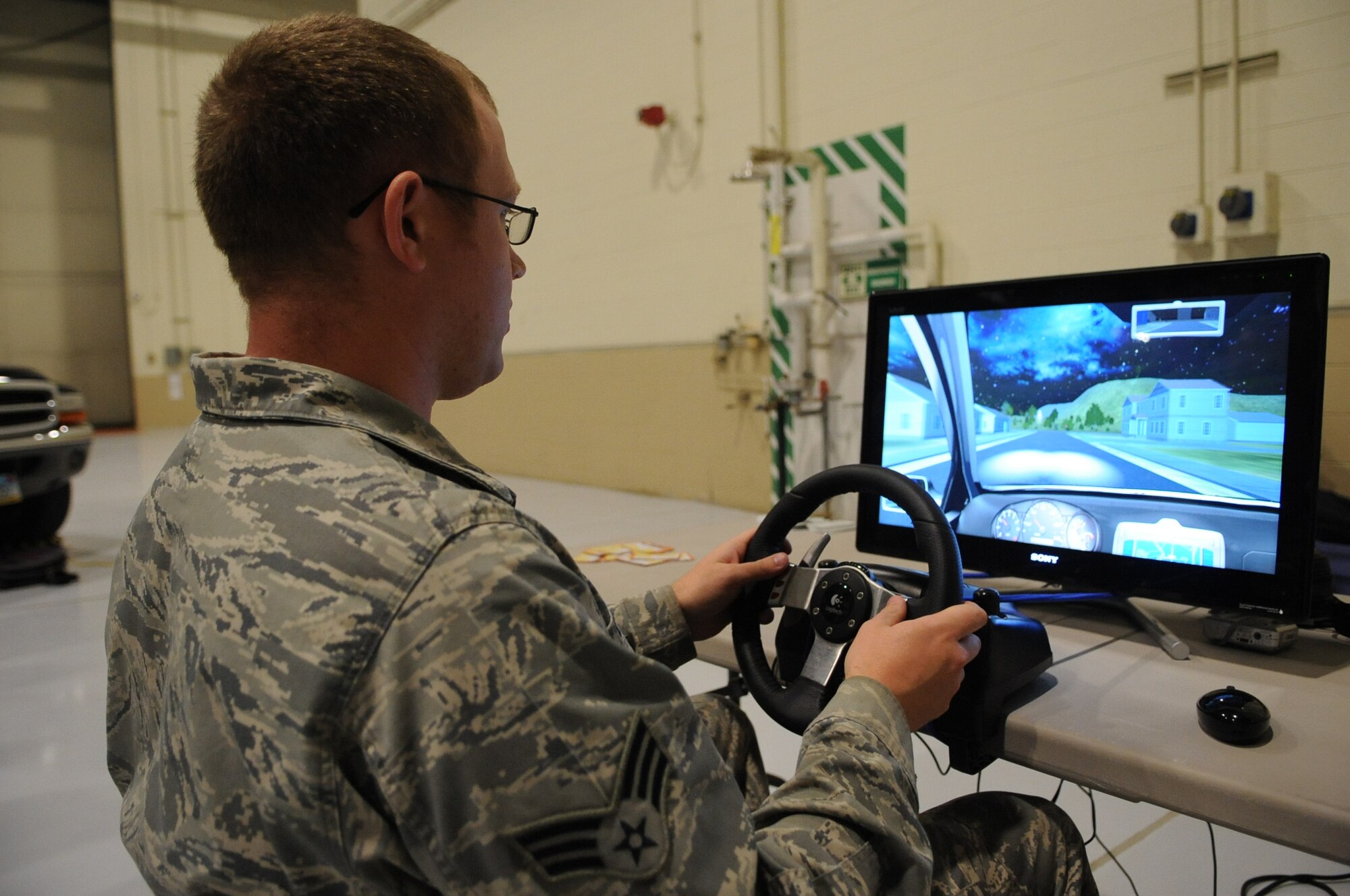 Senior Airman Kevin O’Brien, 319th Civil Engineer Squadron, tests a distracted driving simulator at Wing Safety Day on Grand Forks Air Force Base, N.D., on Nov. 5, 2012. Wing Safety Day featured speakers from the base and local community to promote safe practices for the coming winter. (U.S. Air Force photo/Staff Sgt. Amanda N. Grabiec)
