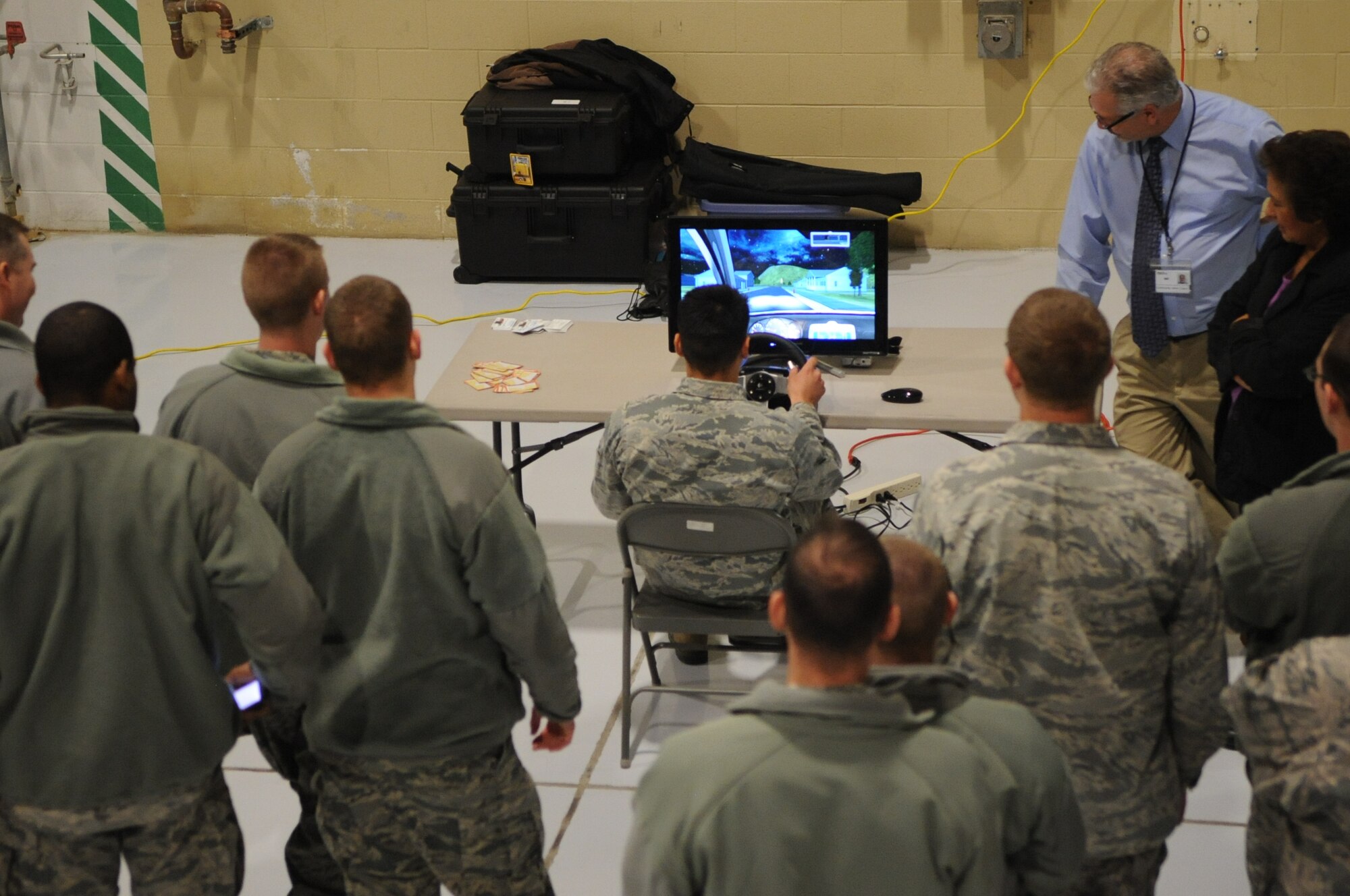Airmen observe a distracted driving simulator at Wing Safety Day on Grand Forks Air Force Base, N.D., on Nov. 5, 2012. Wing Safety Day featured speakers from the base and local community to promote safe practices for the coming winter. (U.S. Air Force photo/Staff Sgt. Amanda N. Grabiec)