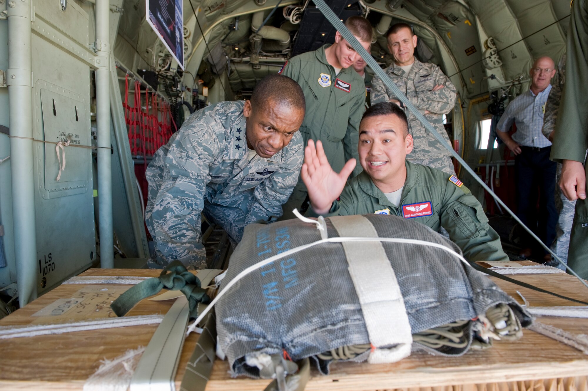 Staff Sgt. Jacinto Melendrez, 317th Operations Support Squadron, showcases the capabilities of a low cost low altitude cargo to Lt. Gen. Darren McDew, 18th Air Force commander, Nov. 7, 2012, at Dyess Air Force Base, Texas. During a group all call, McDew outlined his priorities to 317th Airlift Group Airmen. (U.S. Air Force photo by Airman 1st Class Jonathan Stefanko/ Released)