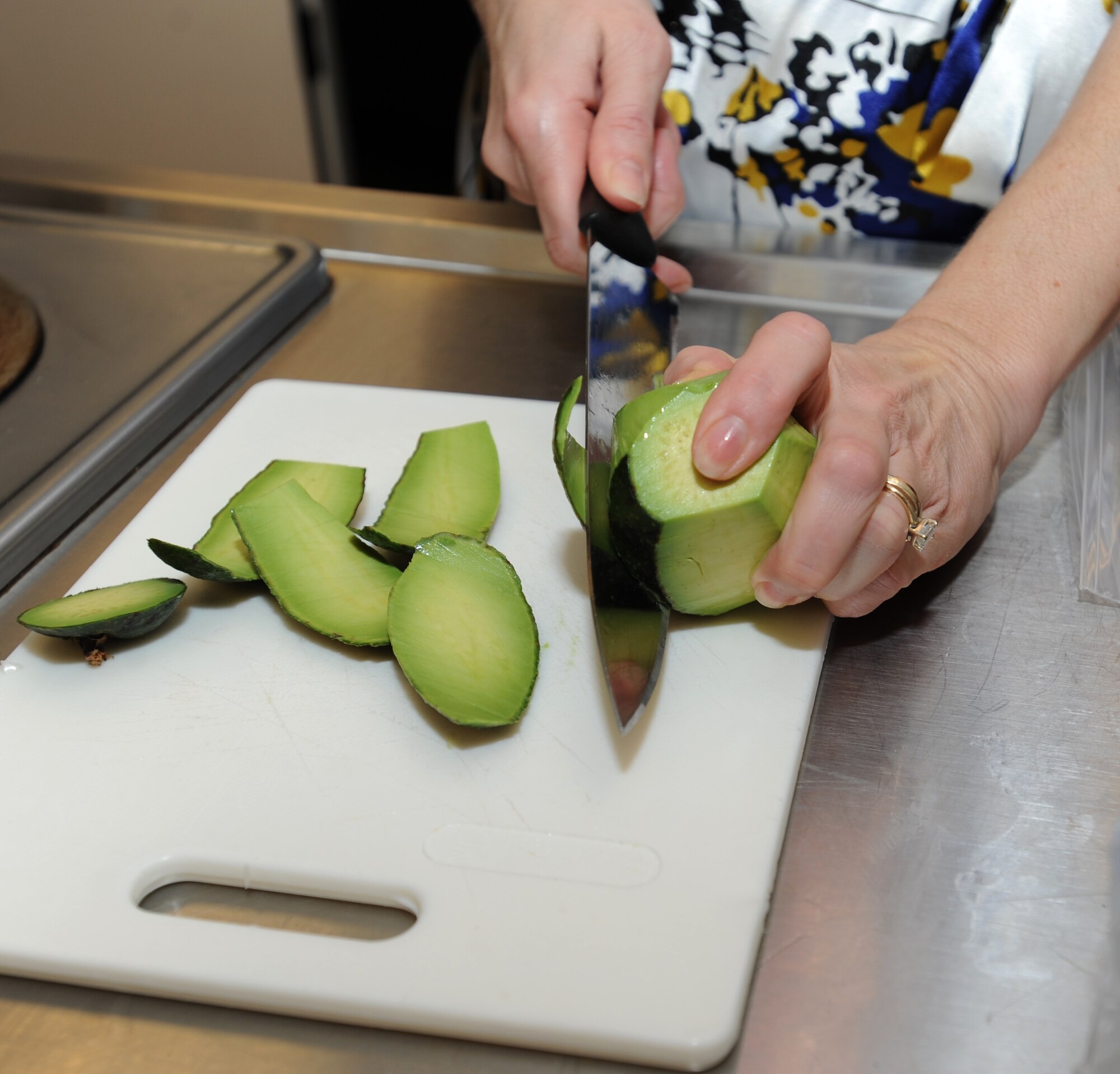 Tracy Conder, Health and Wellness Center registered dietician, prepares an avocado for a recipe during a healthy holiday eating class at Langley Air Force Base, Va., Nov. 13, 2012. Conder prepared food for the class to demonstrate that healthy cooking can still be flavorful and easy to make. (U.S. Air Force photo by Airman 1st Class Teresa Aber/Released)
