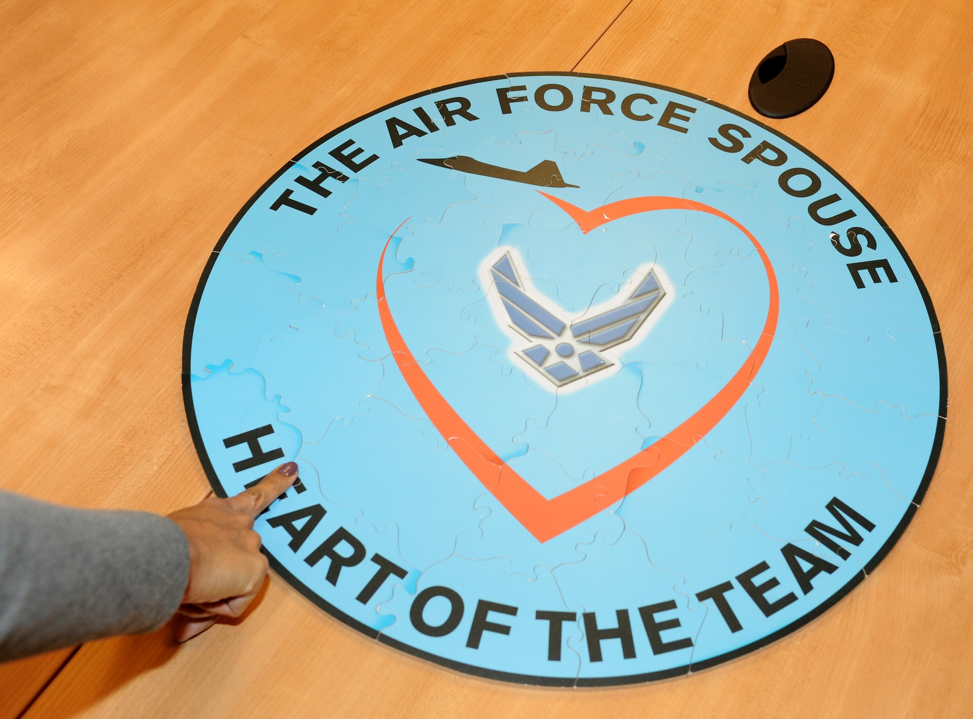 U.S. Air Force spouses put together a puzzle as part of a team building exercise during the Heart Link orientation program at Langley Air Force Base, Va., Nov. 9, 2012. Spouses were briefed on a variety of topics to help them understand their role in the military in support of the operational mission (U.S. Air Force photo by Airman 1st Class Teresa Aber/Released)