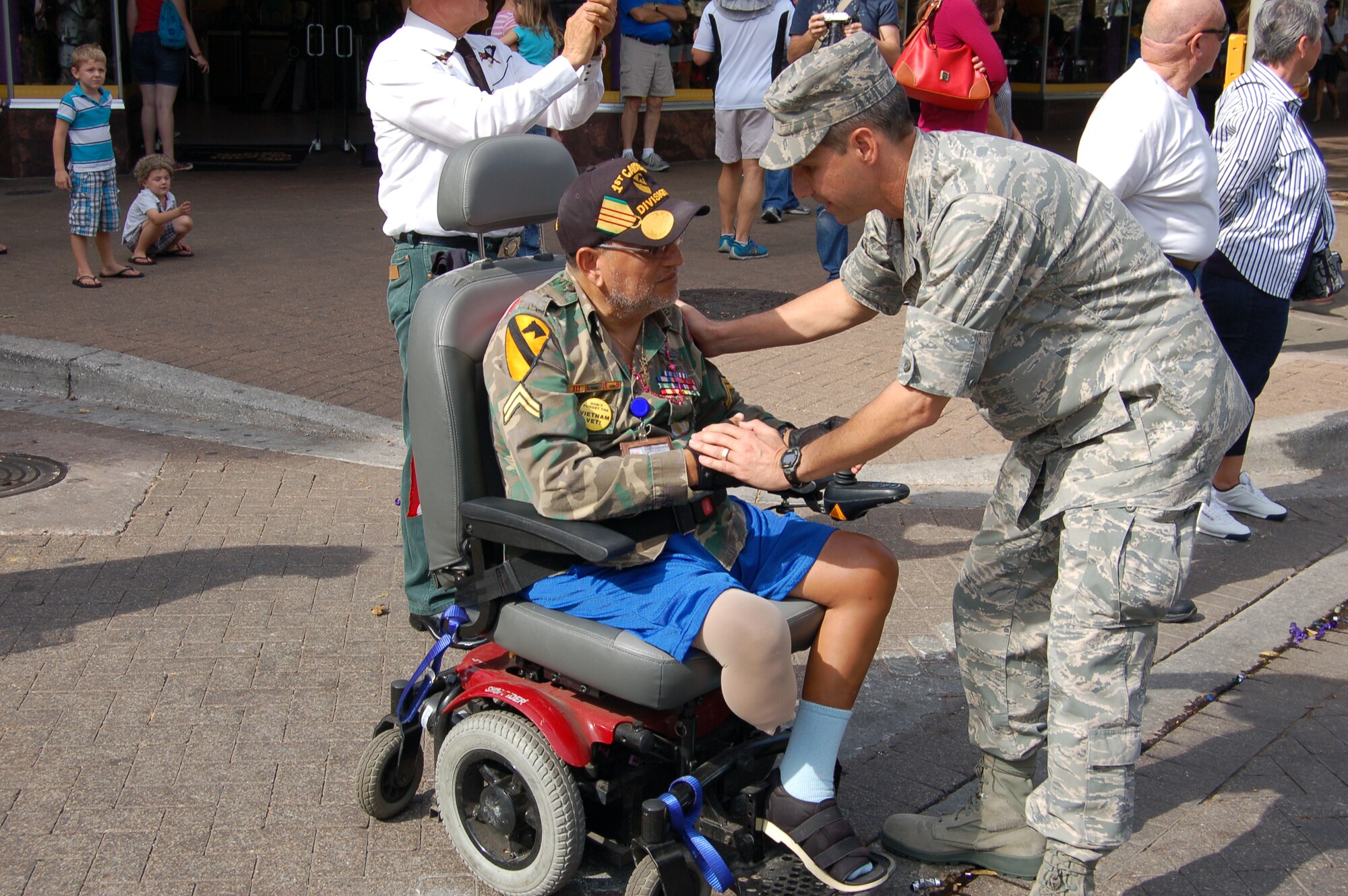 Col. Jeffrey T. Pennington, 433rd Airlift Wing commander, thanks a military veteran for his service during the 13th Annual Veterans Day parade, held Nov. 10 in San Antonio, Texas.  The 433rd "Alamo Wing" is a C-5 Galaxy equipped, Air Force Reserve unit located at Joint Base San Antonio-Lackland. (U.S. Air force Photo/Elsa Martinez)