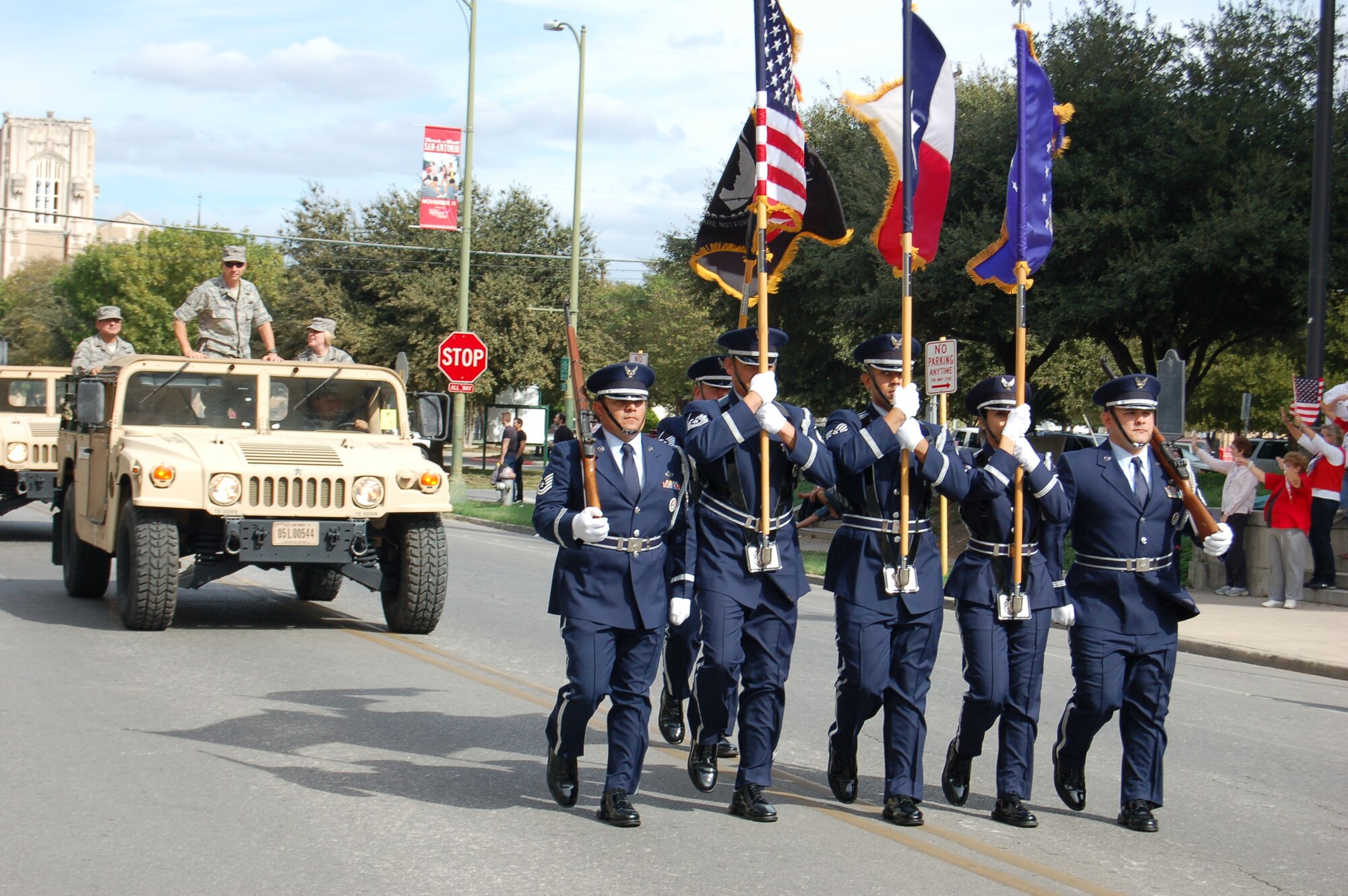 Col. Jeffrey T. Pennington, 433rd Airliflt Wing commander, rides in a military vehicle, following the 433rd AW ceremonial honor unit as they participate in the 13th Annual Veterans Day parade, held Nov. 10 in San Antonio, Texas.  The 433rd "Alamo Wing" is a C-5A Galaxy equipped, Air Force Reserve unit located at Joint Base San Antonio-Texas.