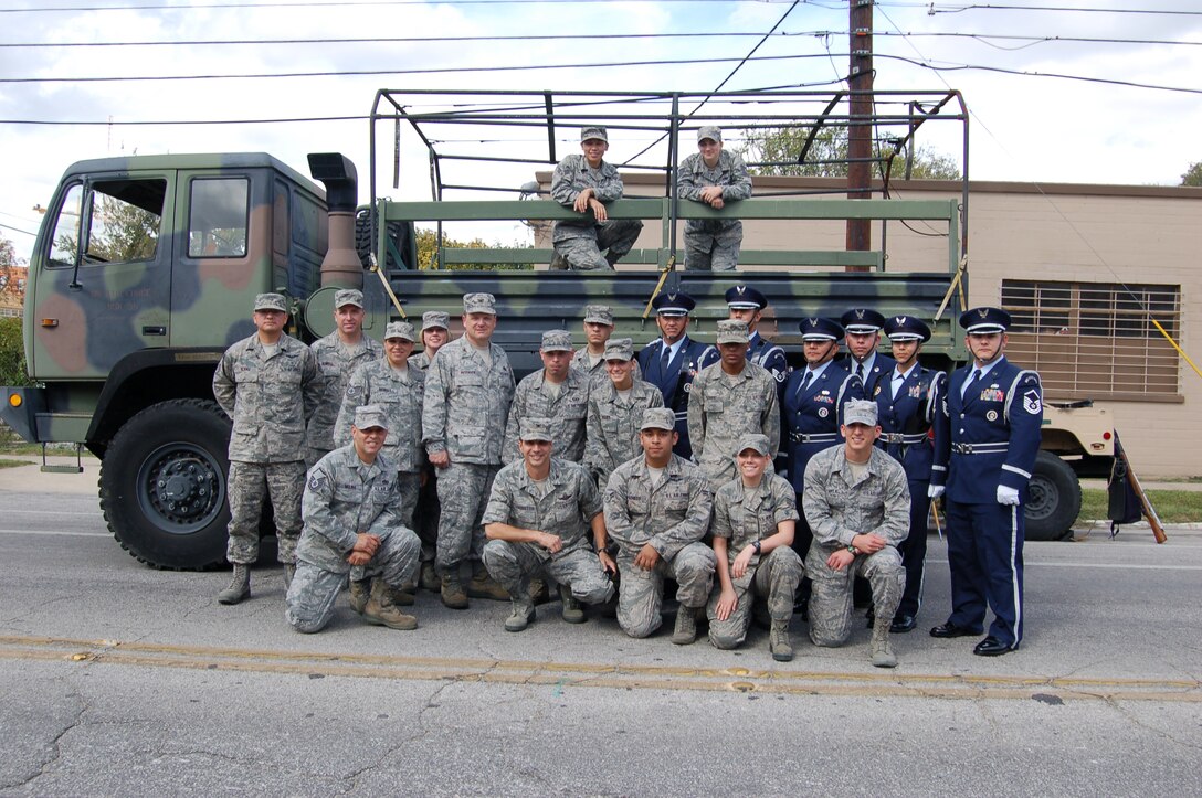 Col. Jeffrey T. Pennington, 433rd Airlift Wing commander, poses kneeling, second left, with troops who participated in the 13th annual Veterans Day parade in San Antonio on Nov. 10.  The 433rd "Alamo Wing" is a C-5 Galaxy equipped, Air Force Reserve unit located at Joint Base San Antonio-Lackland. (U.S. Air Force Photo/Elsa Martinez)