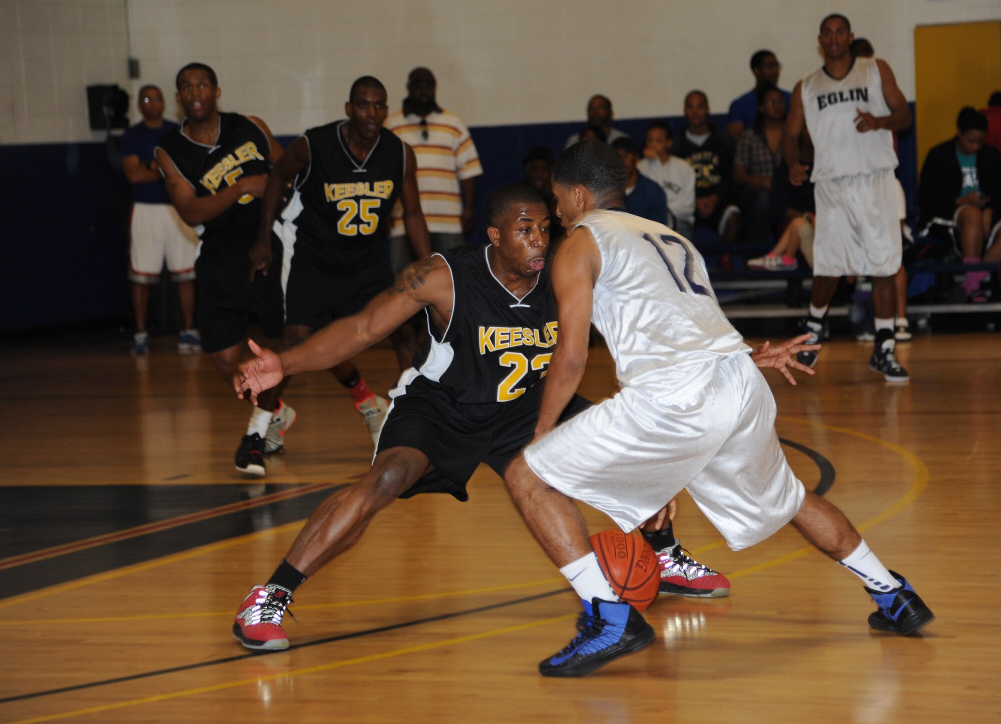 Justin Gachett, Keesler, plays defense against Devron Herron, Eglin Air Force Base, during a varsity basketball game Nov. 10, 2012, at the Blake Fitness Center, Keesler Air Force Base, Miss.  Keesler defeated Eglin, 80-71.  The women’s varsity team also defeated Eglin, 83-48.  (U.S. Air Force photo by Kemberly Groue)