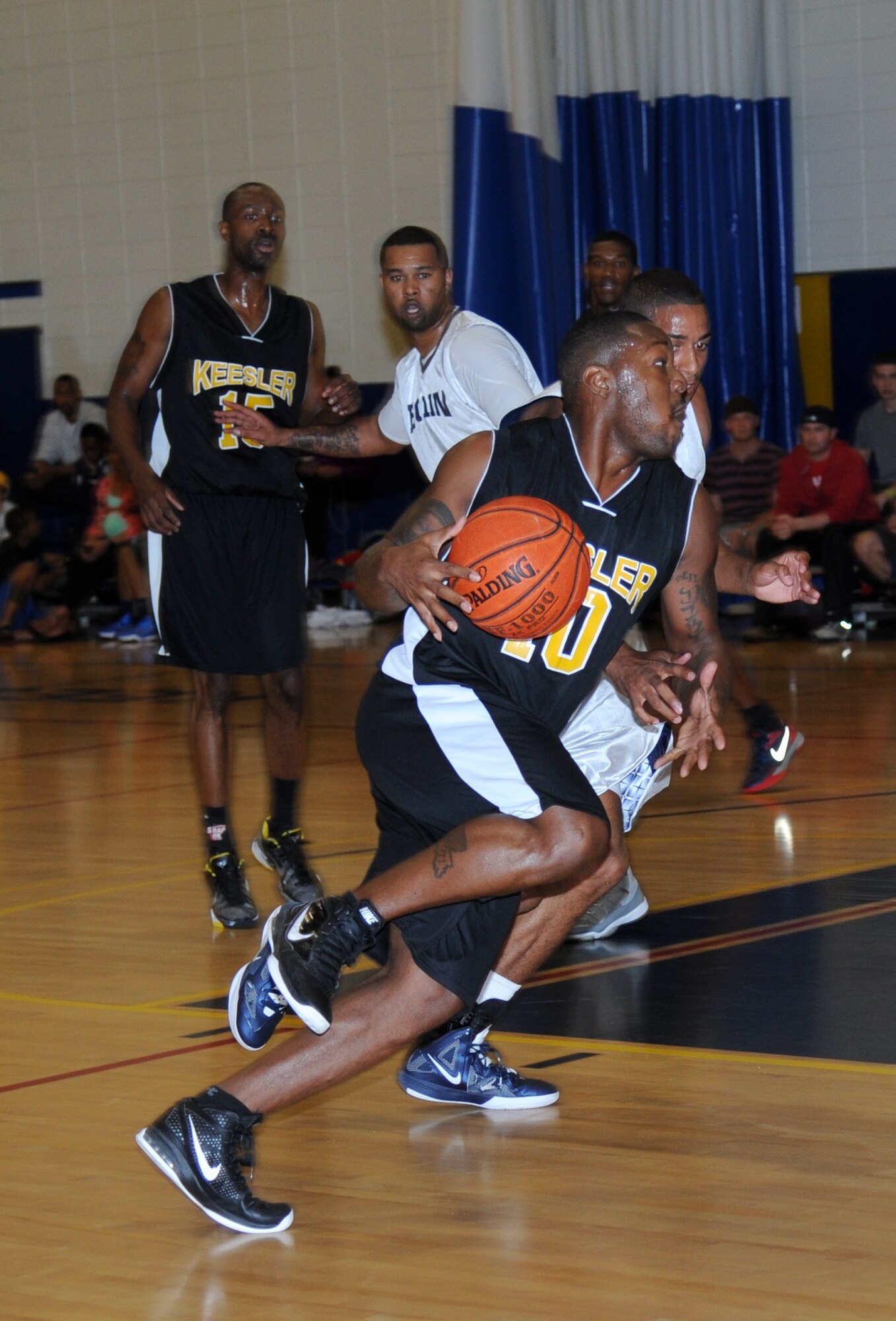 Daryl Jones, Keesler, heads to the goal looking for an open shot during a varsity basketball game against Eglin Air Force Base, Fla., Nov. 10, 2012, at the Blake Fitness Center, Keesler Air Force Base, Miss.  Keesler defeated Eglin, 80-71.  The women’s varsity team also defeated Eglin, 83-48.  (U.S. Air Force photo by Kemberly Groue)