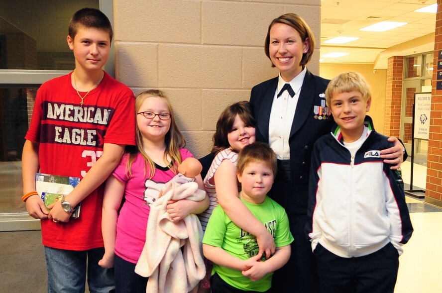 U.S. Air Force Staff Sgt. Rachel Trimble, USAF Heritage of America Band vocalist, and a group of children pose for a photo after a concert at Jesse Carson High School in China Grove, N.C., Nov. 9, 2012. Many children accompanied their parents and grandparents to the free show saluting military service-members. Trimble hails from Colorado. (U.S. Air Force photo/Airman 1st Class Aubrey White/Released)