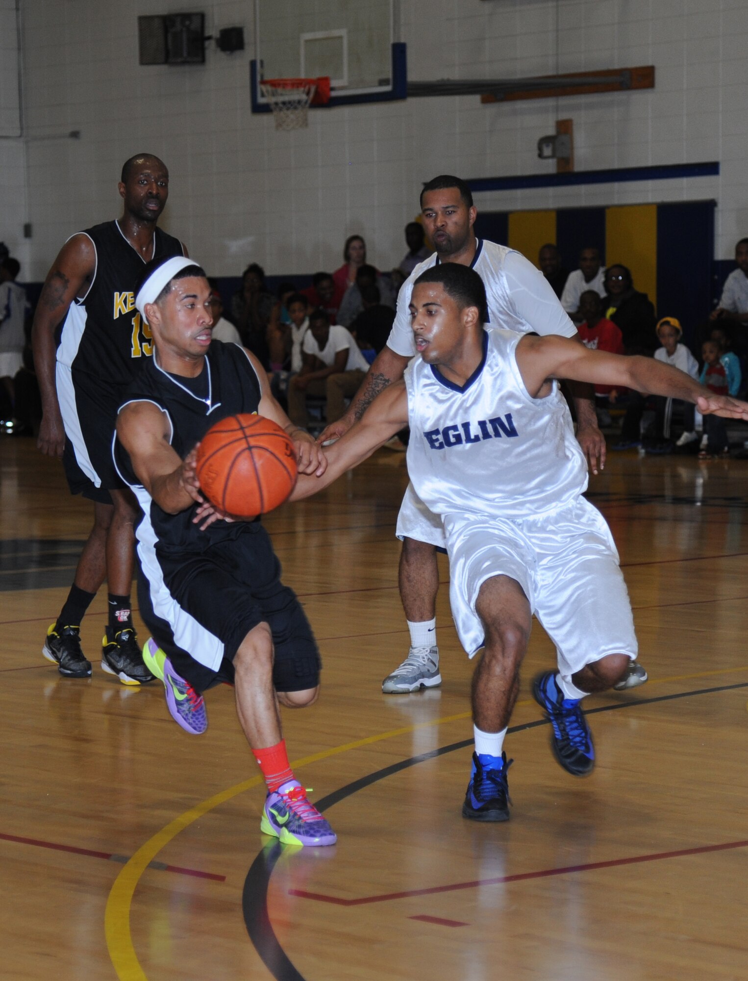 Mario McKnight, Keesler, drives the ball toward the goal as Devron Herron, Eglin Air Force Base, Fla., plays defense closely during a varsity basketball game Nov. 10, 2012, at the Blake Fitness Center, Keesler Air Force Base, Miss.  Keesler defeated Eglin, 80-71.  The women’s varsity team also defeated Eglin, 83-48.  (U.S. Air Force photo by Kemberly Groue)