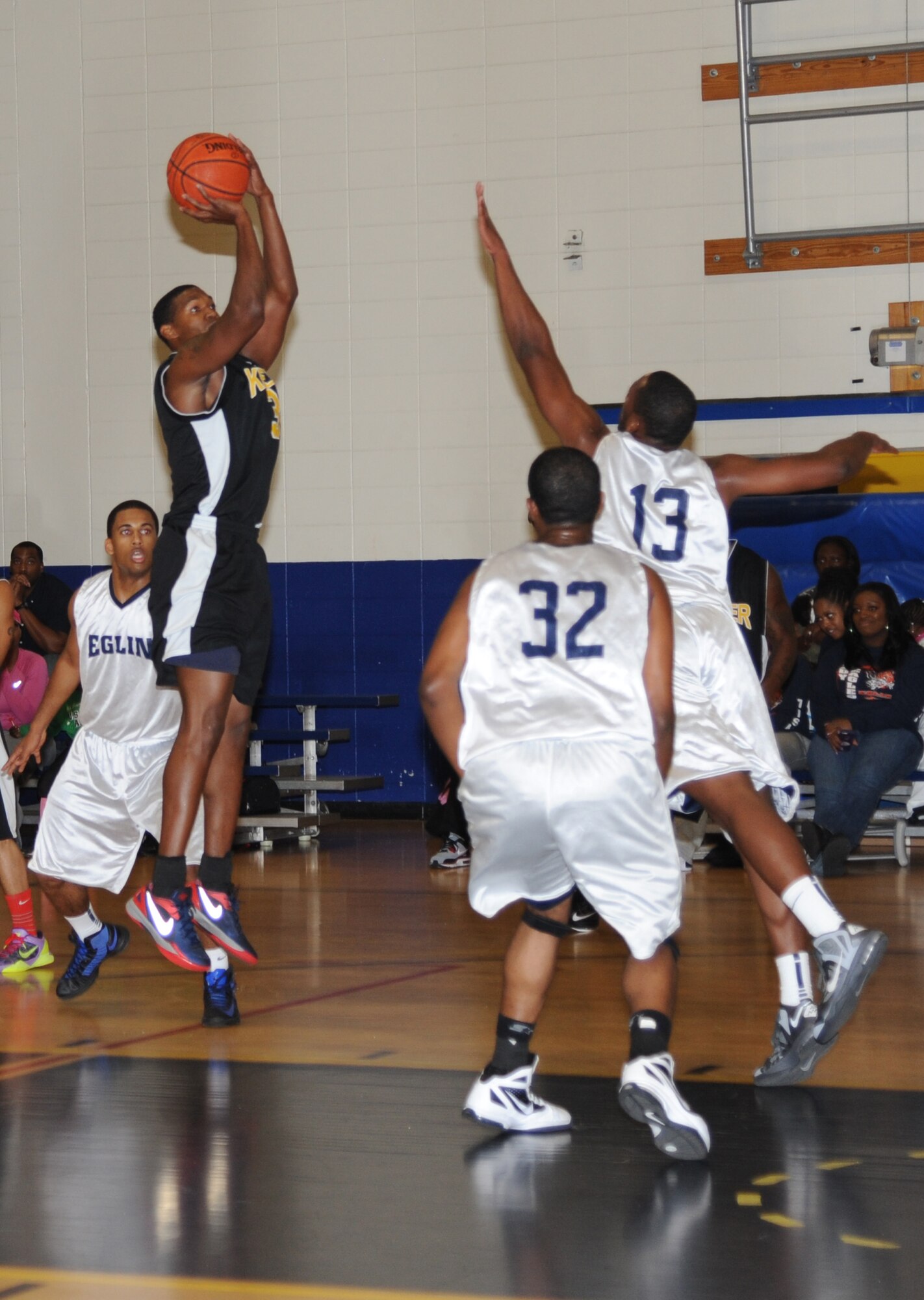 Mark Pough, Keesler, takes a two-point jump shot as team members from Eglin Air Force Base, Fla., attempt to make the block during a varsity basketball game Nov. 10, 2012, at the Blake Fitness Center, Keesler Air Force Base, Miss.  Keesler defeated Eglin, 80-71.  The women’s varsity team also defeated Eglin, 83-48.  (U.S. Air Force photo by Kemberly Groue)