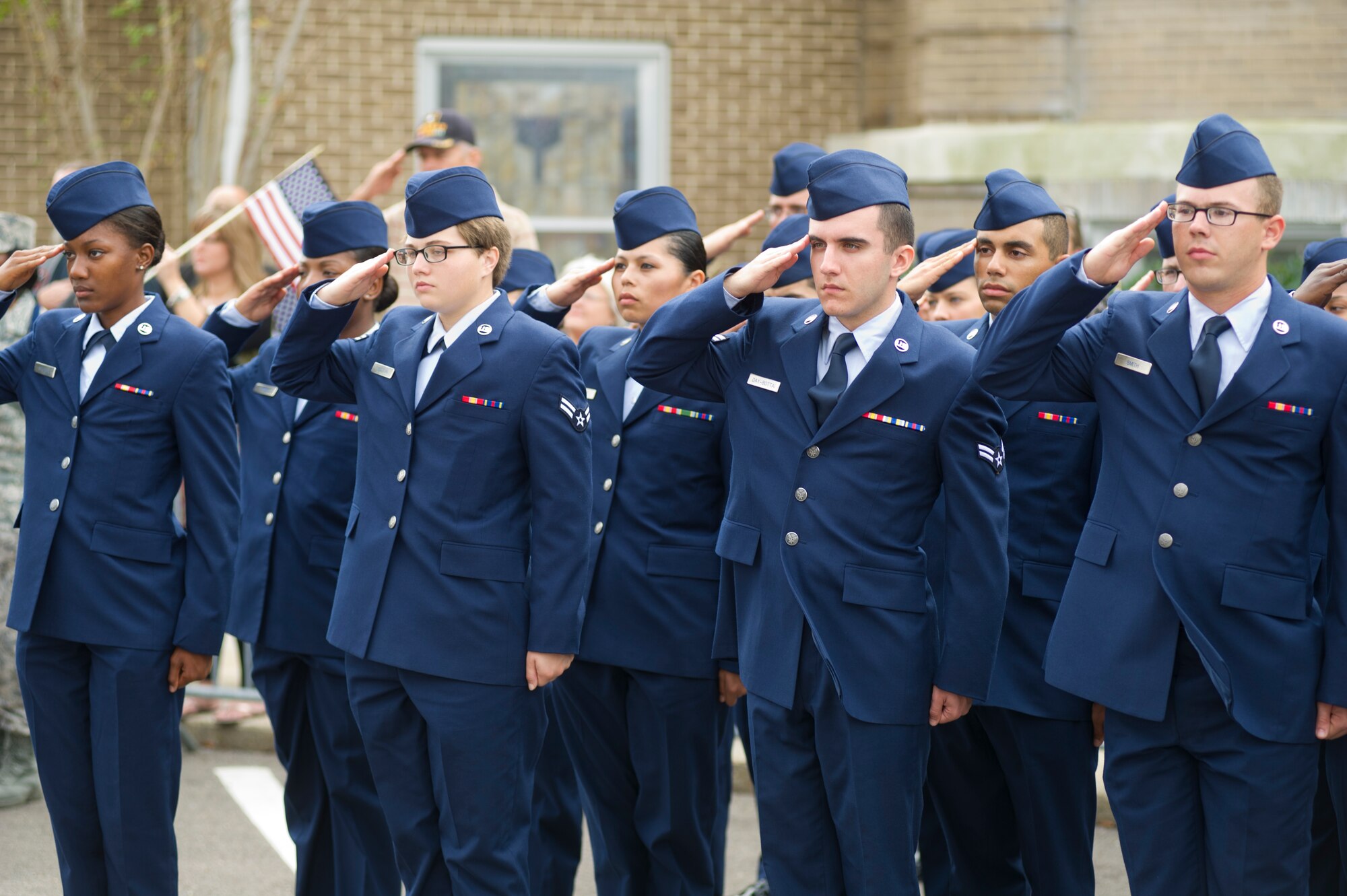 Airmen from Keesler Air Force Base, Miss., salute during the singing of the national anthem during the 12th annual Gulf Coast Veteran's Parade Nov. 10, 2012, in Gulfport.  Brig. Gen. Brad Spacy, 81st Training Wing commander, and Col. Rene Romero, 81st TRW vice commander, led participants from Keesler.  Keesler marching units included the honor guard, the 50 state flags carried by the 334th Training Squadron, student marching groups from the 335th and 336th Training Squadrons and the 81st Training Group’s drum and bugle corps. (U.S. Air Force photo by Adam Bond)