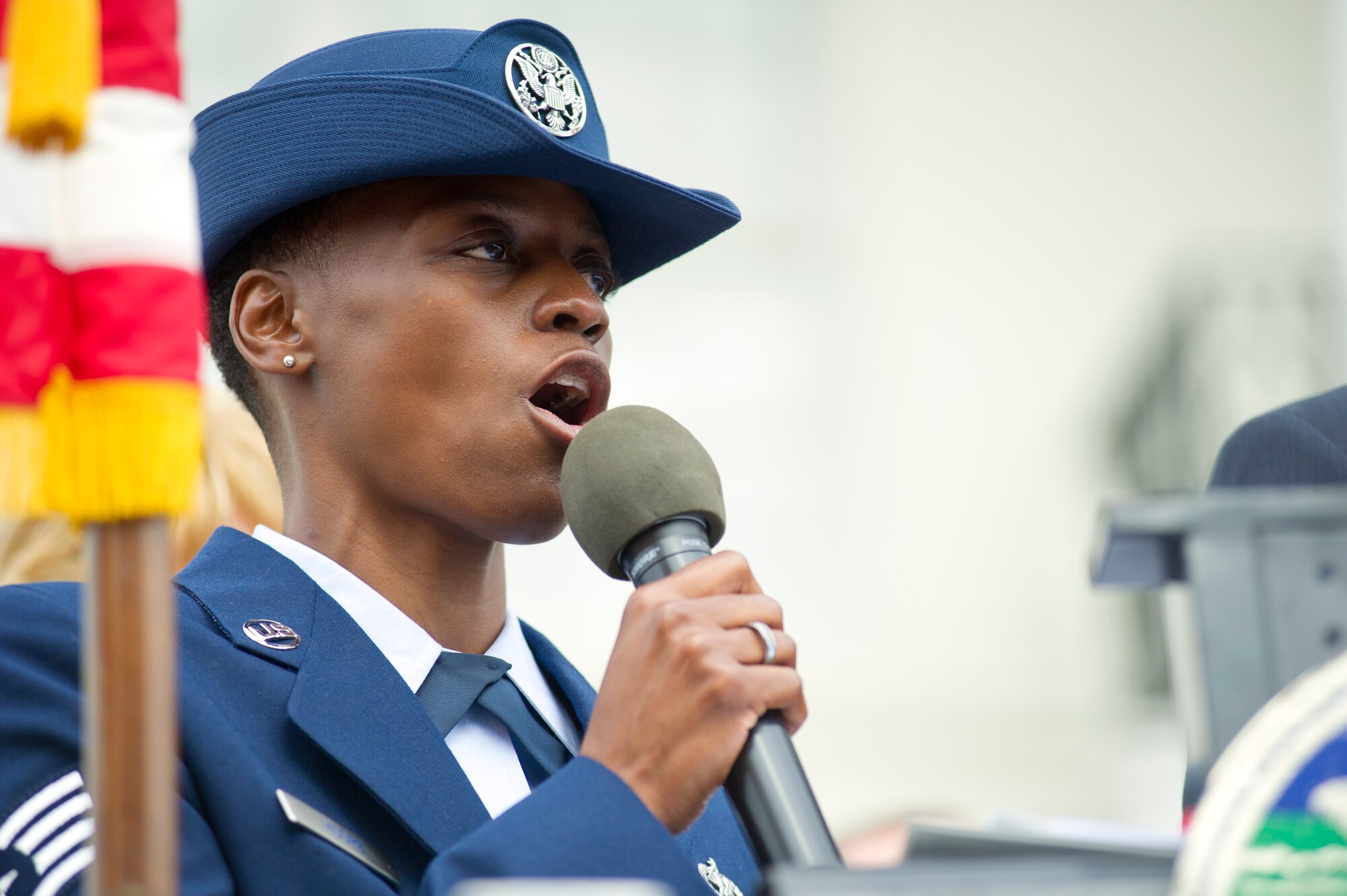 Staff Sgt. Karen Moore, 403rd Wing, Keesler Air Force Base, Miss., sings the National Anthem during the 12th annual Gulf Coast Veteran's Parade Nov. 10, 2012, in Gulfport.  Brig. Gen. Brad Spacy, 81st Training Wing commander, and Col. Rene Romero, 81st TRW vice commander, led participants from Keesler.  Keesler marching units included the honor guard, the 50 state flags carried by the 334th Training Squadron, student marching groups from the 335th and 336th Training Squadrons and the 81st Training Group’s drum and bugle corps. (U.S. Air Force photo by Adam Bond)