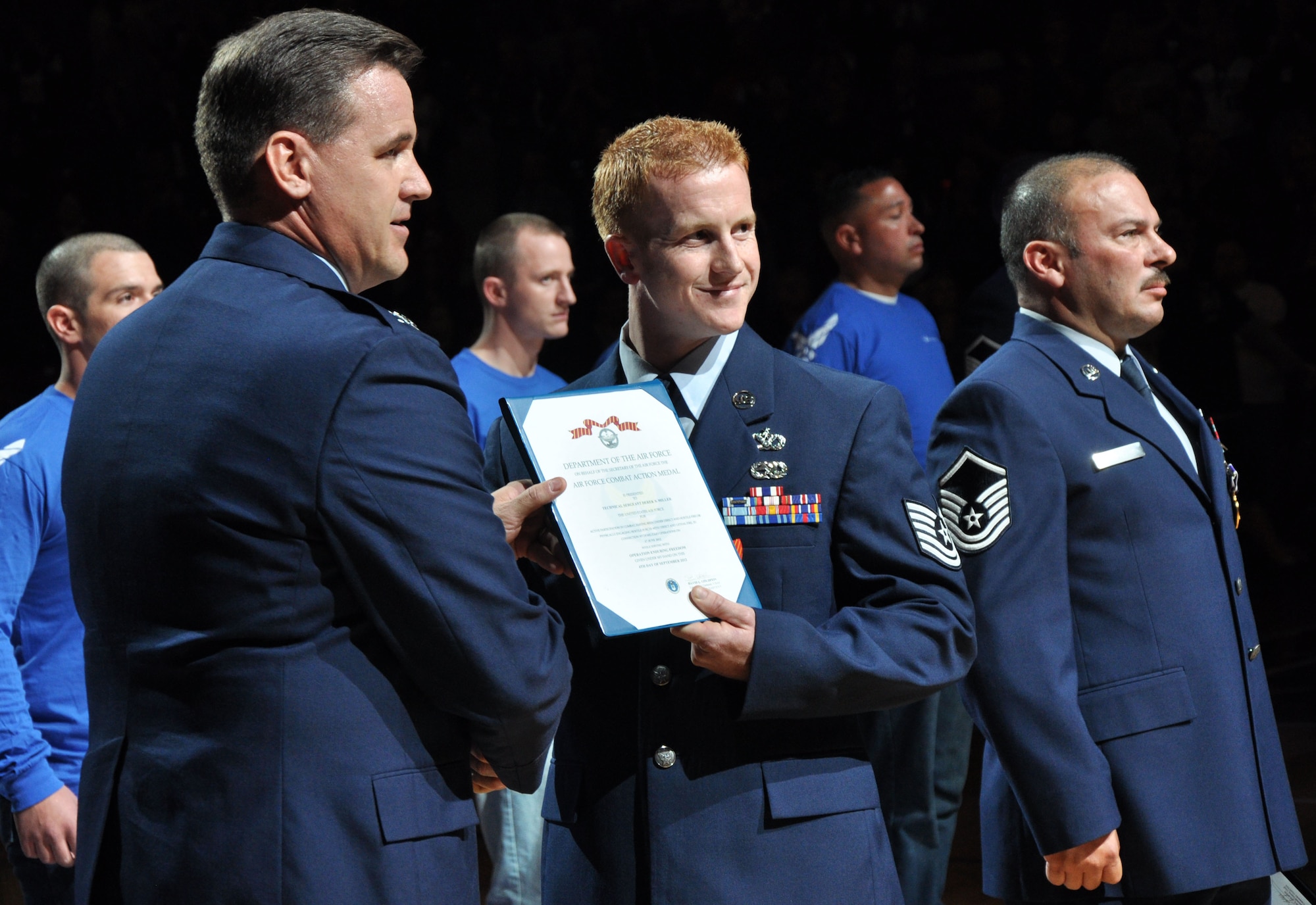 Col. Kevin Cavanagh, 940th Wing commander, presents Tech. Sgt. Derek with the Air Force Combat Action Medal for his actions in Operation Enduring Freedom at the Sacramento Kings military appreciation game in Sacramento, Calif., Nov 9, 2012. The Kings held a military appreciation night in honor of Veterans Day. (U.S. Air Force photo by Staff Sgt. Robert M. Trujillo/Released)