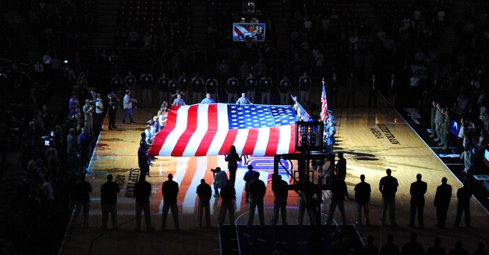 Servicemembers, veterans and volunteers hold the American flag during the opening ceremonies and singing of the National Anthem at a Sacramento Kings game in Sacramento, Calif., Nov. 9, 2012. The Kings held a military appreciation night in honor of Veterans Day. (U.S. Air Force photo by Staff Sgt. Robert M. Trujillo/Released)