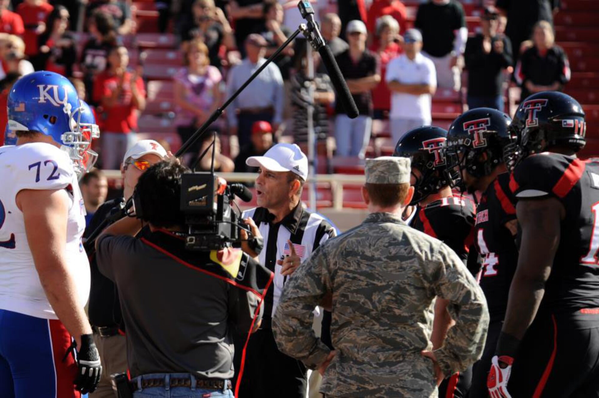 U.S. Air Force Col. Bill West, 27th Special Operations Group commander, stands on the field to perform the Texas Tech University coin toss in Lubbock, Texas, Nov. 9, 2012. More than 500 members from the 27th Special Operations Wing at Cannon Air Force Base, N.M., attended the game in honor of Military Appreciation Day. (U.S. Air Force photo/Senior Airman Jette Carr)