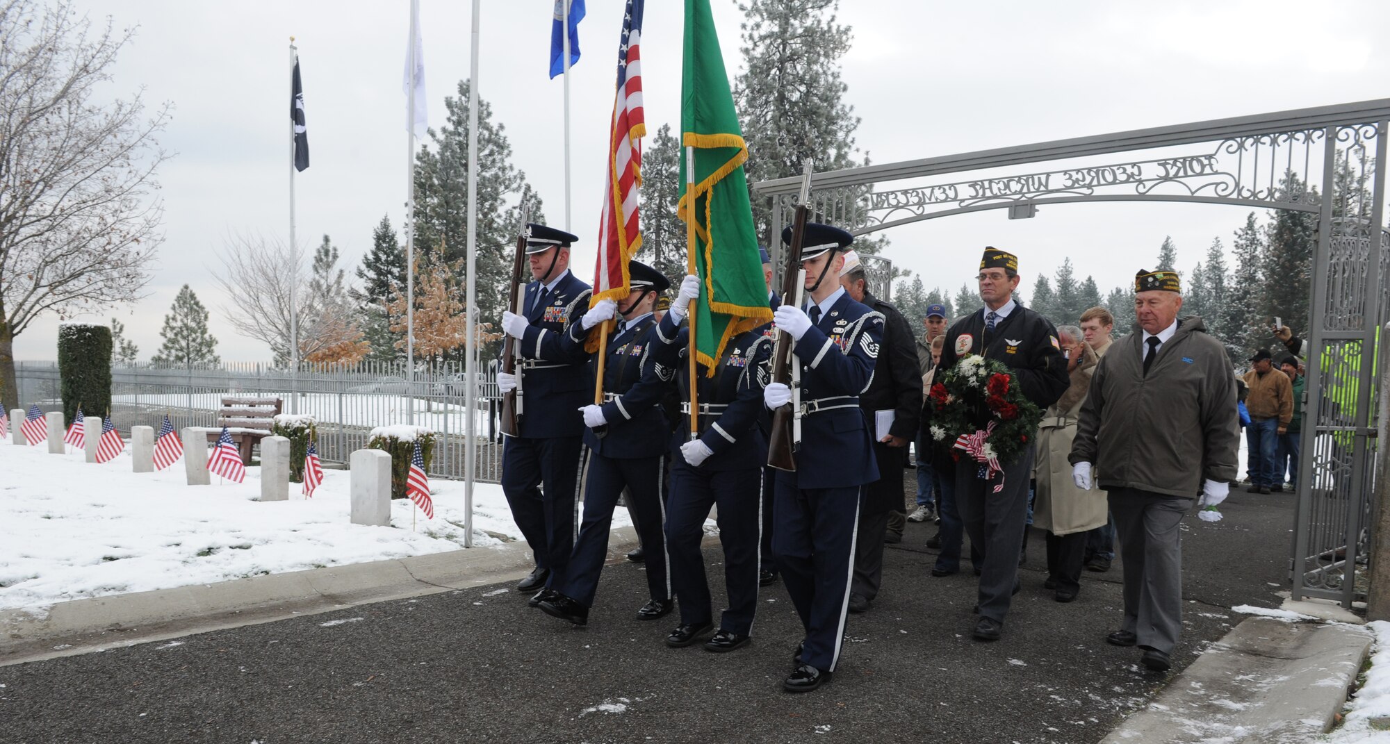 Fairchild Air Force Base Honor Guard members lead a parade of people in Fort George Wright cemetery for a Veterans Day ceremony in  Spokane, Wash., Nov. 11, 2012. Airmen visited schools around the region, and met with veterans at the Elks Lodge, the Ft. Wright Cemetery, Spokane Arena and Felts Field. (U.S. Air Force photo by Staff Sgt. Michael Means)