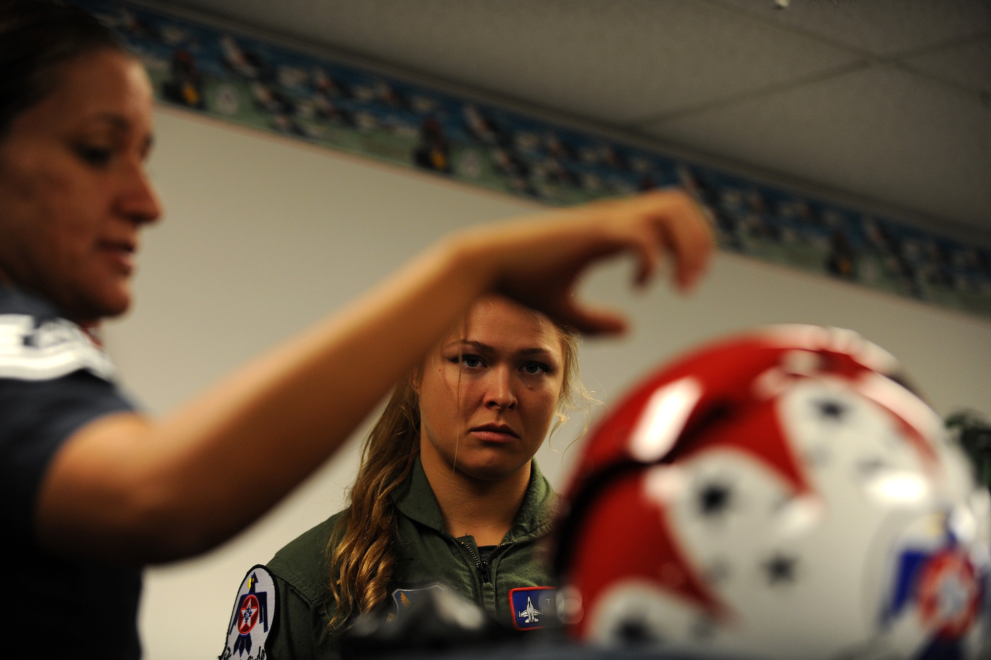 Technical Sgt. Amber Alumpe provides an equipment briefing to mixed martial artist champion, Ronda Rousey, in preparation for her F-16 Fighting Falcon flight at Nellis Air Force Base, Nev., Nov. 9, 2012.
(U.S. Air Force photo/Staff Sgt. Larry E. Reid Jr., Released)